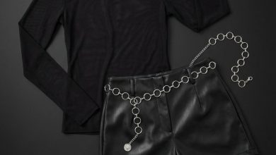 Bold summer fashion outfit for festivals: fuchsia lace-trim camisole, sheer black mesh top, black faux leather shorts, and combat boots. Edgy summer nights out.