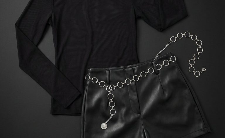 Bold summer fashion outfit for festivals: fuchsia lace-trim camisole, sheer black mesh top, black faux leather shorts, and combat boots. Edgy summer nights out.