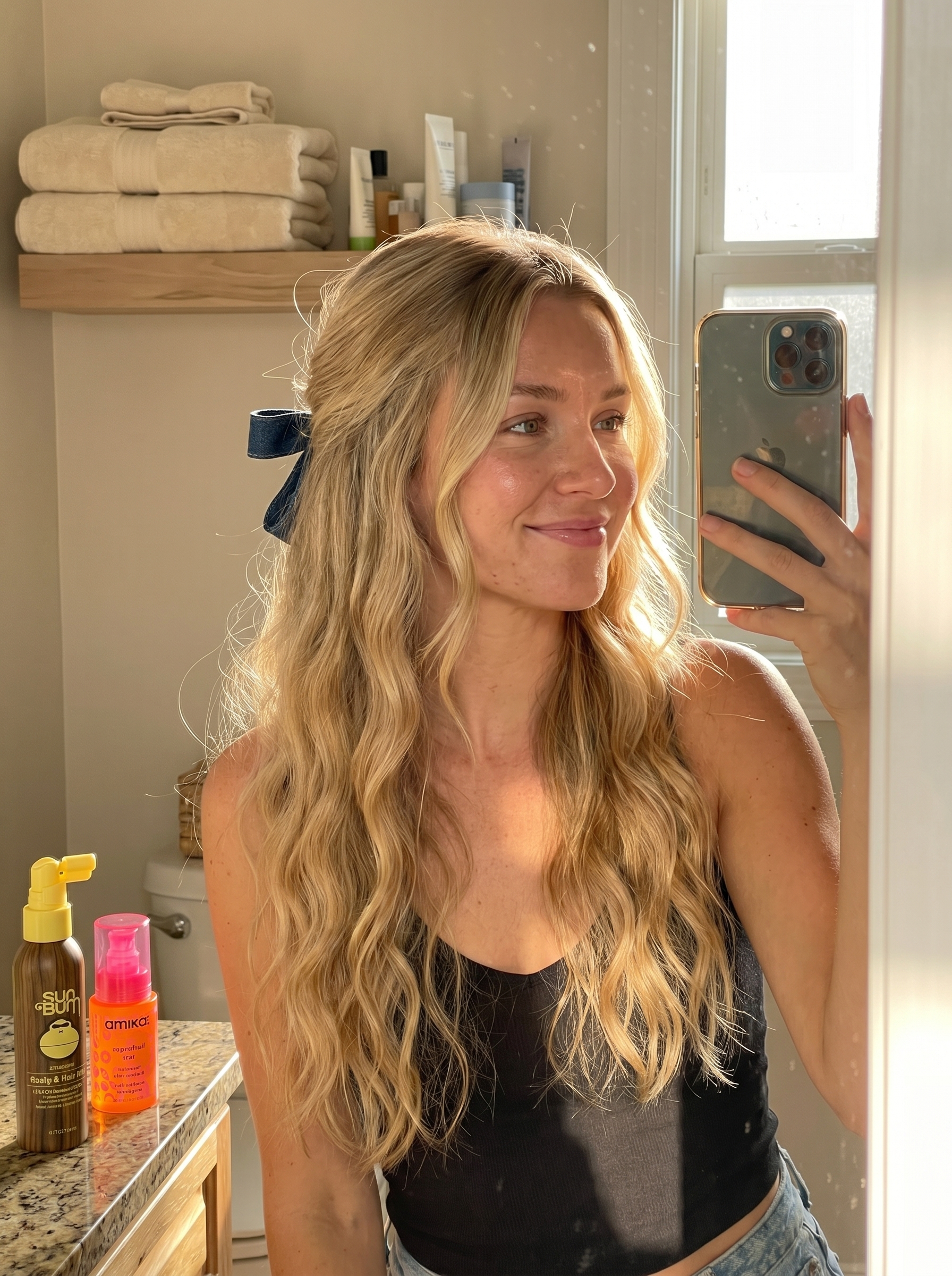 Bohemian coastal cowgirl waves in linen blonde, adorned with a denim hair ribbon, showcasing cool summer hair ideas 2026. This relaxed look uses sea salt spray, UV protection, and lightweight hair oil for a natural, adventurous feel.