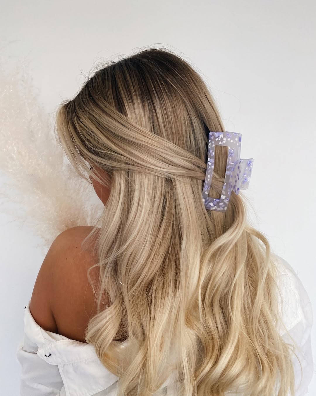 Close-up of a woman with vibrant, cool summer hair ideas 2026, featuring sleek, straight purple-tinted locks framing her face, styled for a chic evening event.