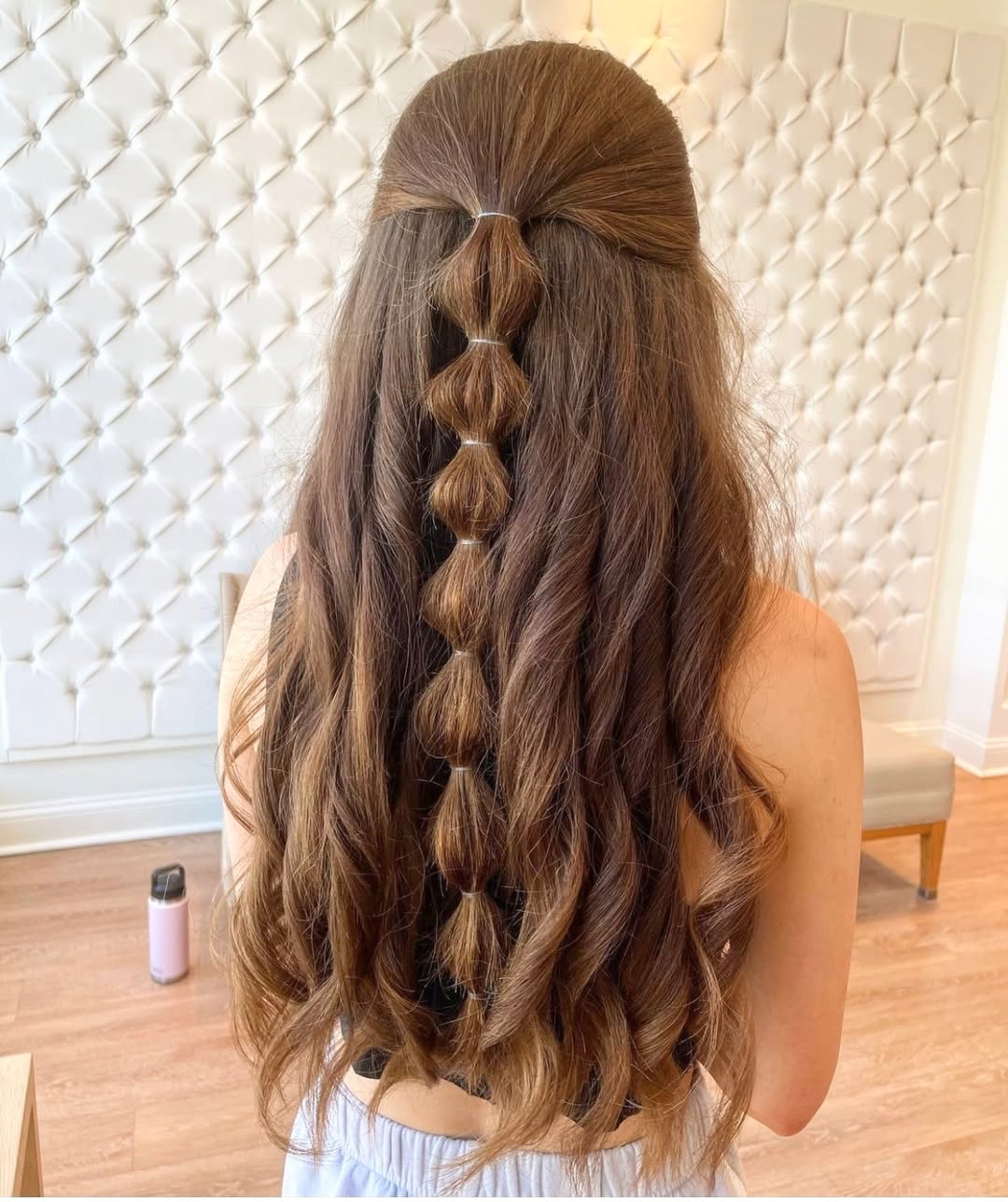 Close-up of a woman with a trendy wavy lob haircut, styled with a casual, windswept look, perfect for cool summer hair ideas. Her light brown hair has subtle highlights, framing her face softly. Ideal for a relaxed yet chic summer vibe.