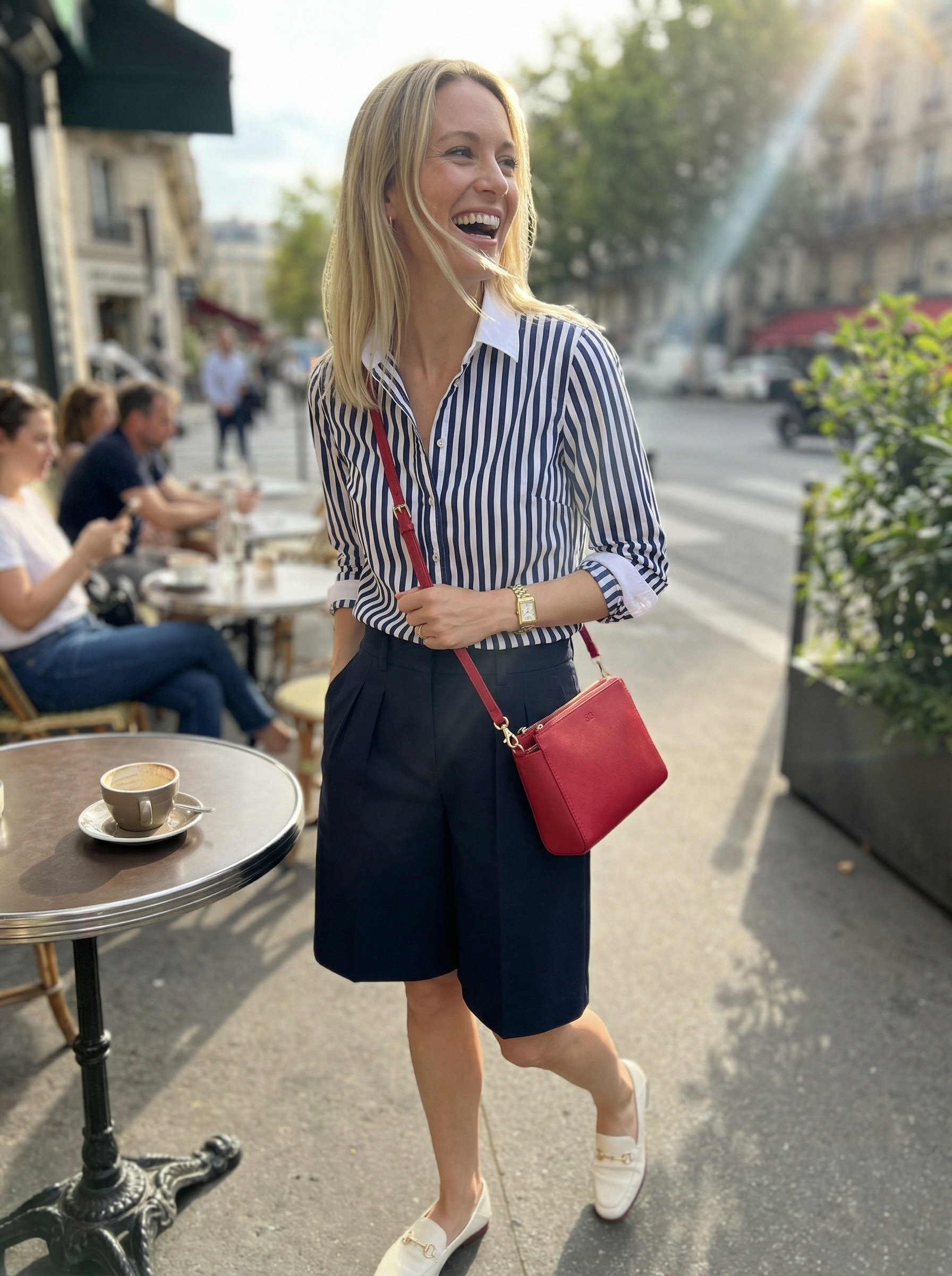 Playful Preppy Summer Style 2024 A preppy summer outfit featuring a navy striped button-down shirt, tailored navy Bermuda shorts, white leather loafers, and a red crossbody bag, offering a cute comfy outfit for summer lunches.