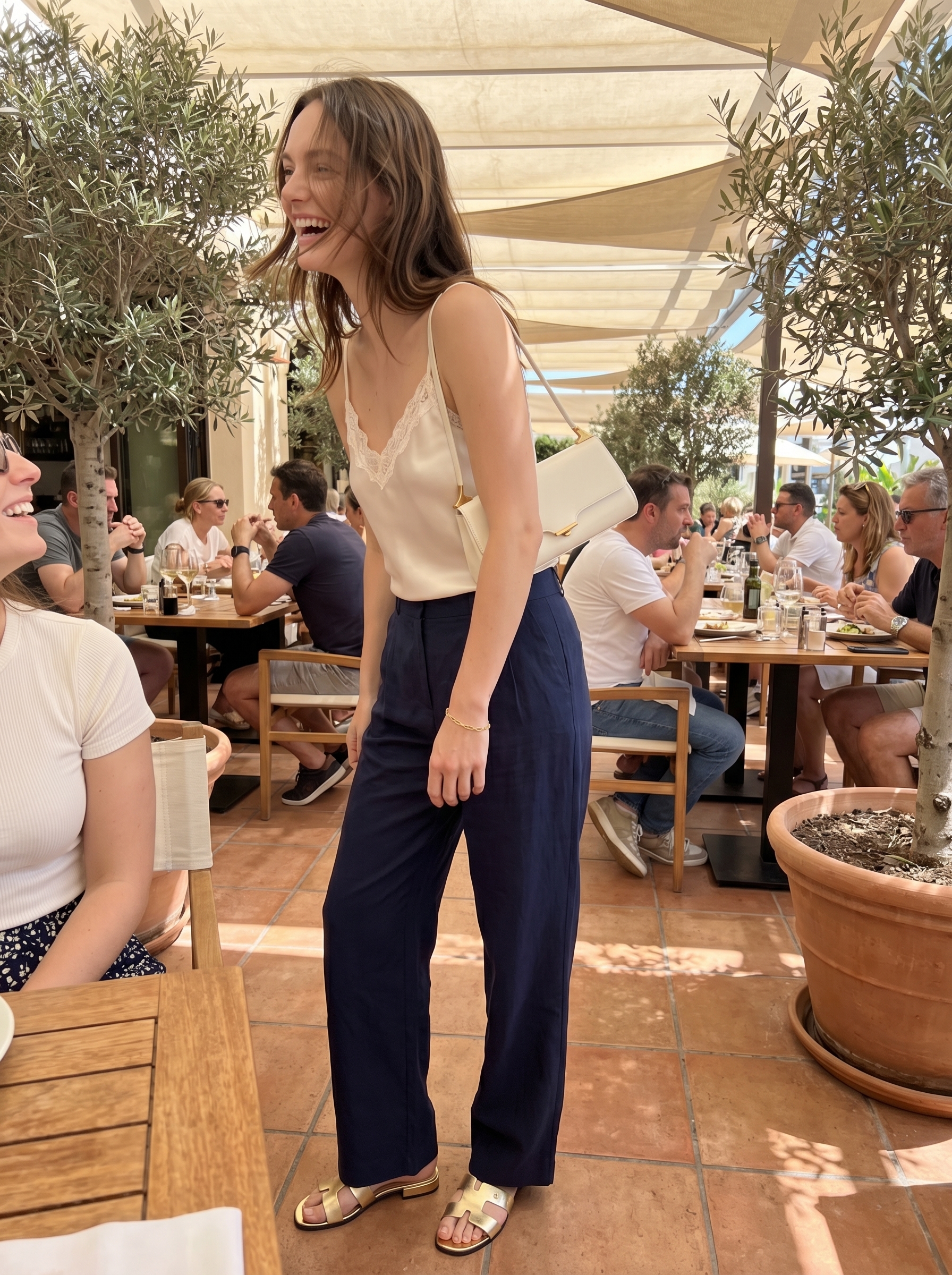 Sophisticated navy wide-leg trousers, a creamy white silk camisole, gold metallic slide sandals, and a structured mini bag, showcasing elegant cute outfits for summer 2026.