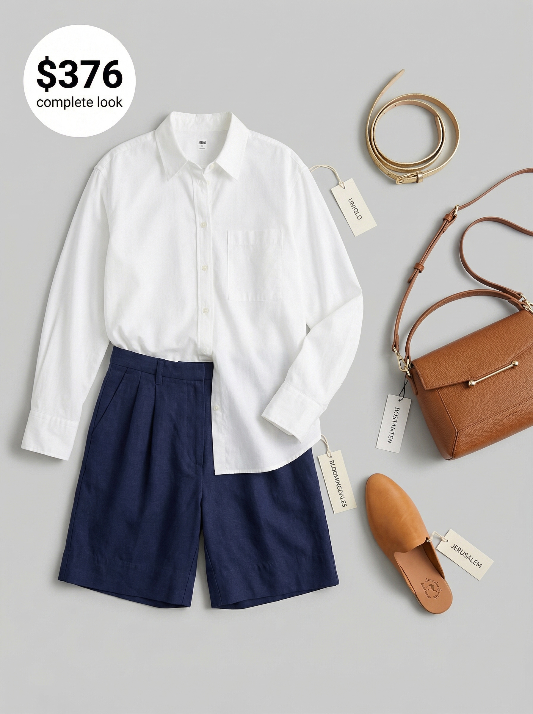 Sophisticated end of summer outfit with navy tailored shorts, a crisp white shirt, tan mules, and a structured shoulder bag.