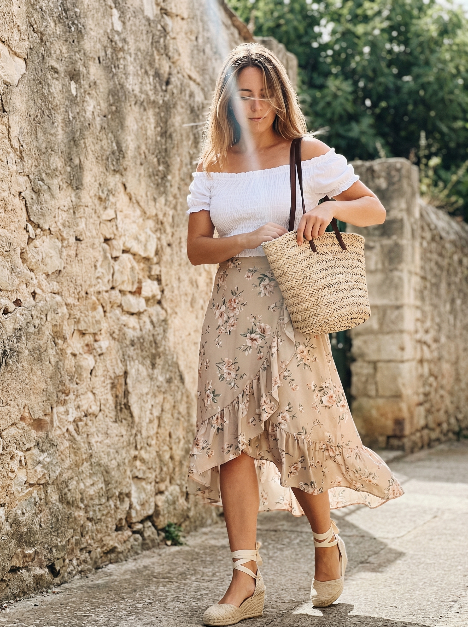 A romantic blush pink floral midi skirt with a cream off-the-shoulder top, perfect for European summer outfits 2026 Tuscan vineyard lunches.