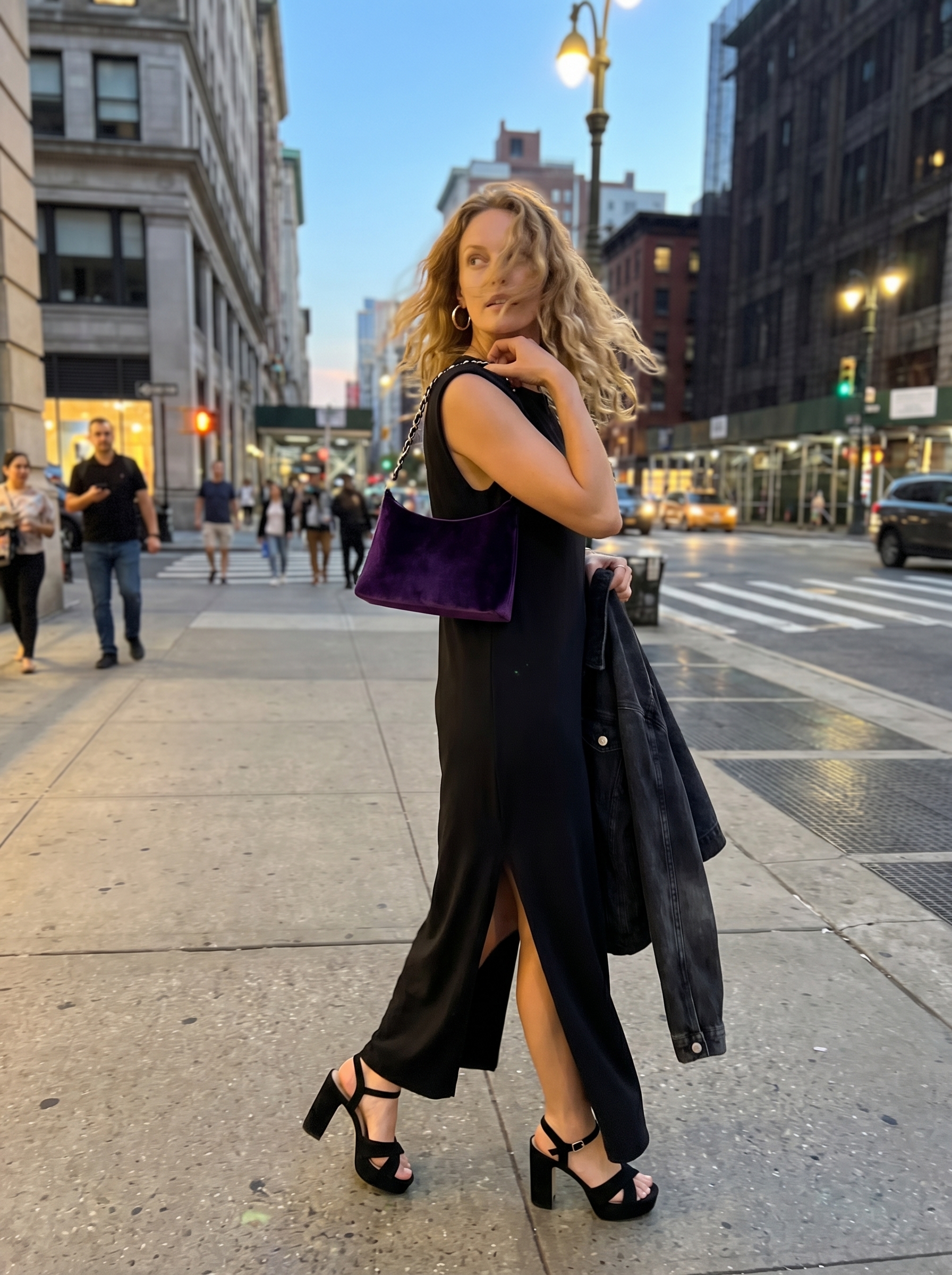 Dark romantic grungy summer outfit 2026 for an outdoor concert, featuring a black sleeveless maxi dress, an oversized denim jacket, platform sandals, and a velvet bag.