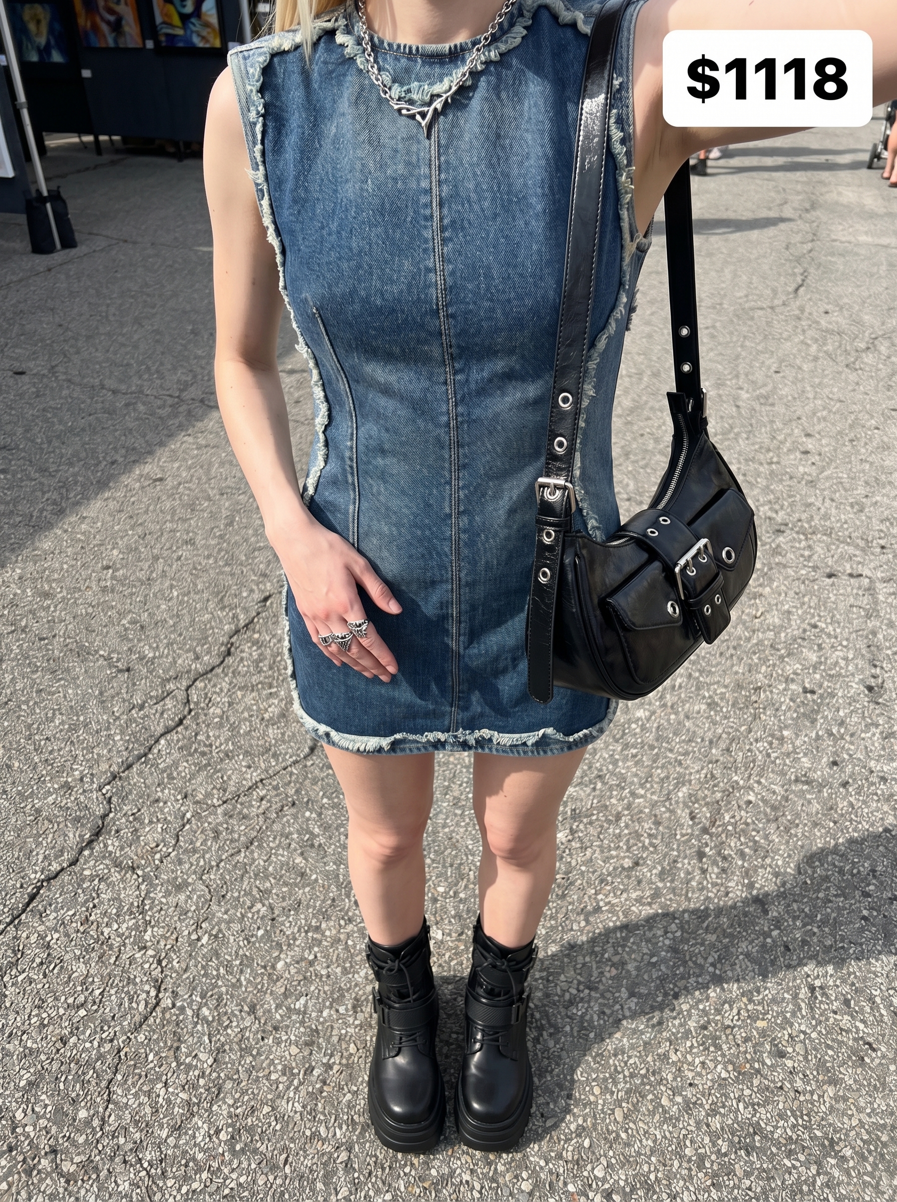 Playful edgy grungy summer outfit 2026 with a deconstructed denim mini dress, chunky platform combat boots, a studded belt, and a silver chain choker, ideal for an art fair.