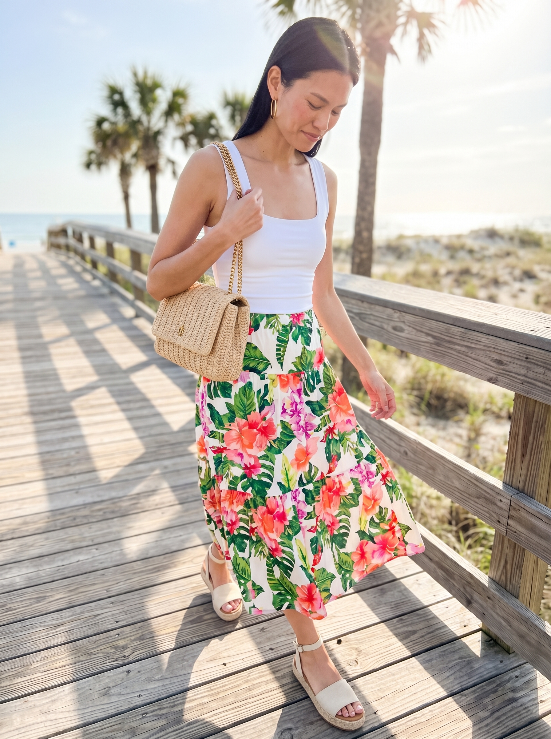 Playful resort wear 2026 outfit with a pink & green floral midi skirt, white knit top, and flat espadrille sandals for a garden party.