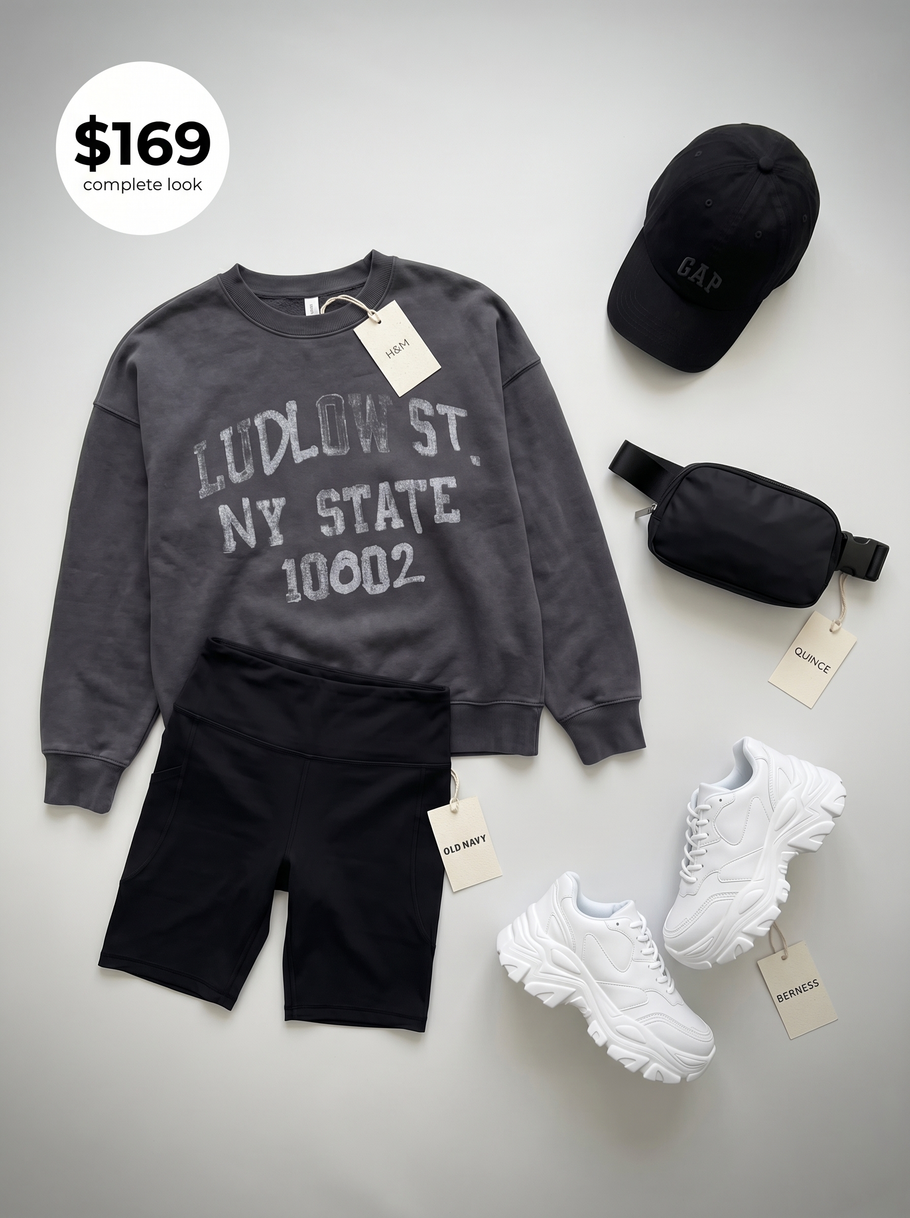 Relaxed school summer outfits 2026 for evening study, including a charcoal graphic sweatshirt, black biker shorts, white platform sneakers, and a baseball cap.