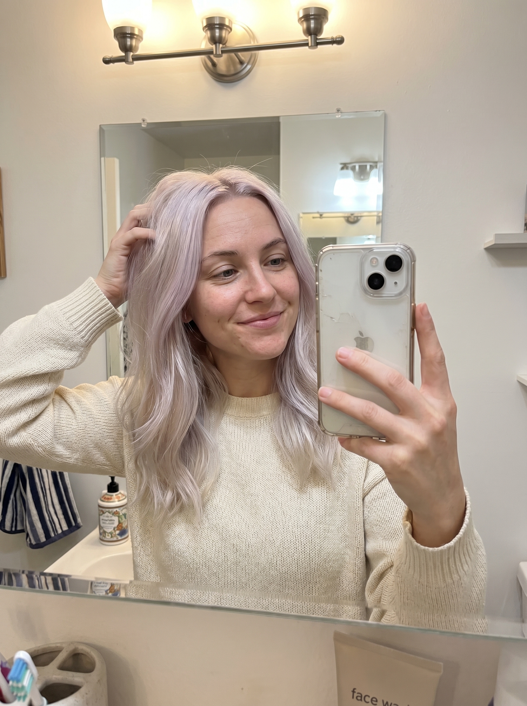 Shimmering pearly iridescent gloss blonde hair, showcasing a beautiful blend of pearl and violet-ash tones. This soft summer blonde hair 2026 is ideal for everyday or special occasions.