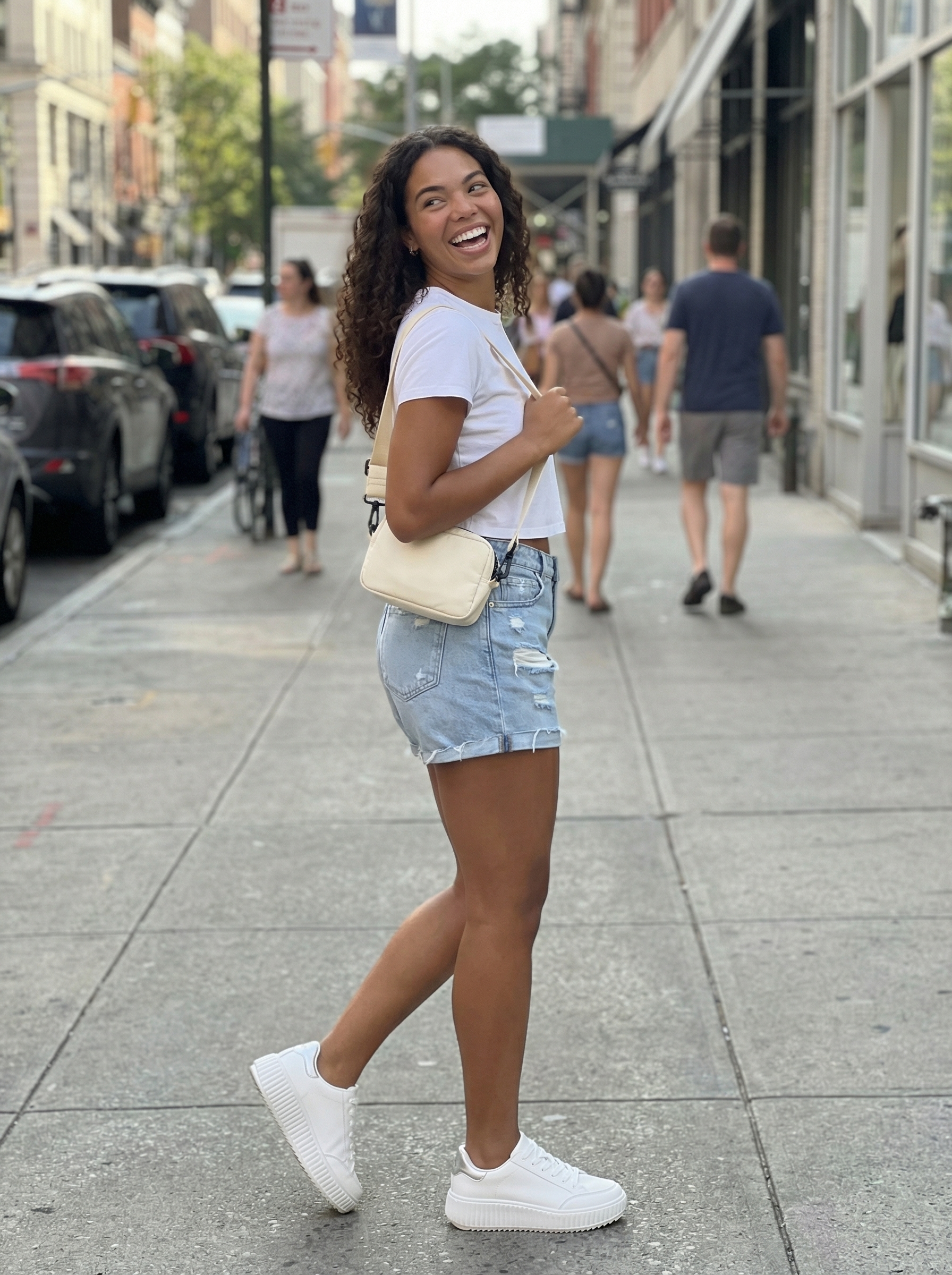 Playful spring summer outfit with bright coral graphic tee, distressed denim shorts, and chunky white platform sneakers. Ideal for outdoor activities.