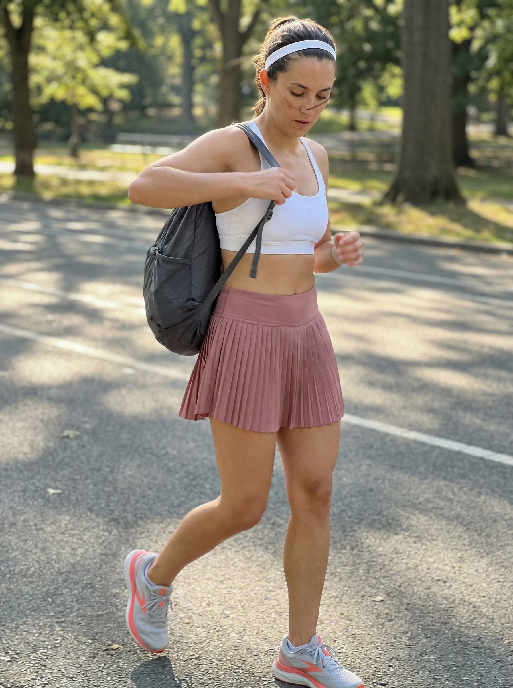 Active dusty rose athletic skirt and white sports bra with lightweight running shoes, perfect for a studio to street summer athleisure outfit 2026.