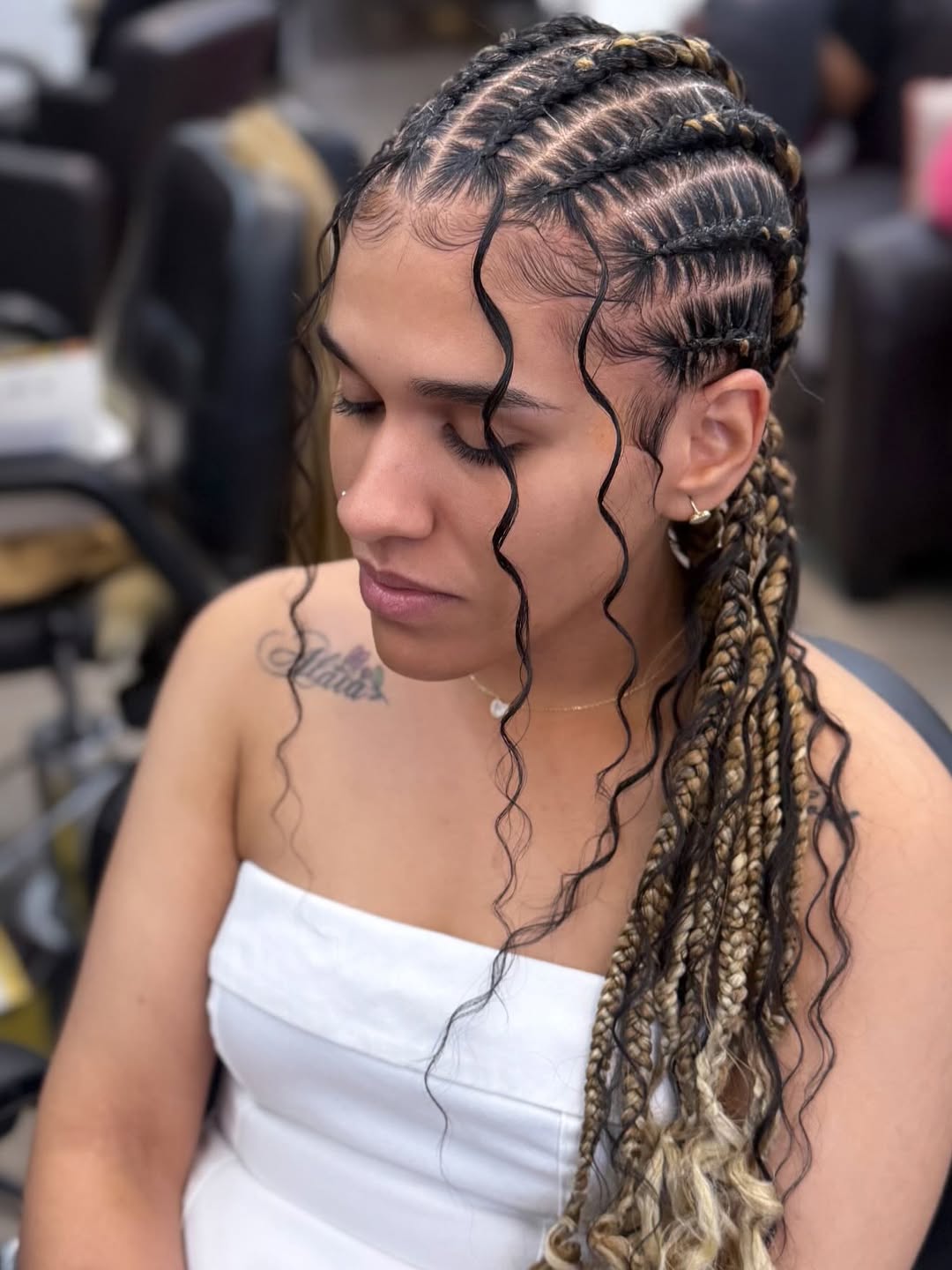 Close-up of a woman with long, dark hair styled in intricate box braids, showcasing a trendy look for summer hairstyles braids 2026.