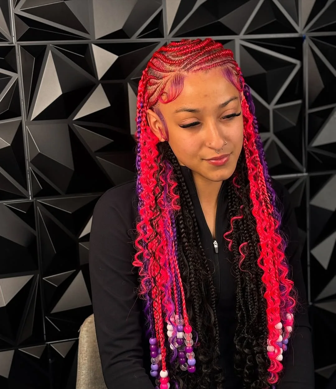 Close-up of a woman with intricate summer hairstyles braids 2026, featuring sleek cornrows styled into a high bun with face-framing twists, perfect for chic casual wear.