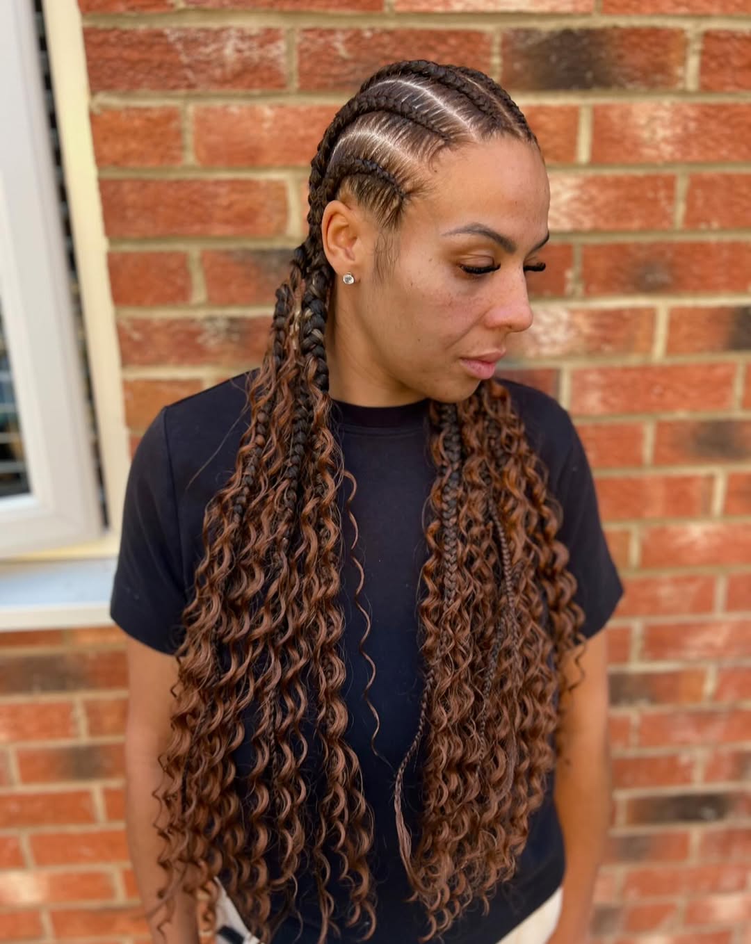 Close-up of a woman with beautiful long dark hair styled in intricate summer hairstyles braids 2026, featuring Dutch braids cascading down her back. Perfect for a chic casual look.
