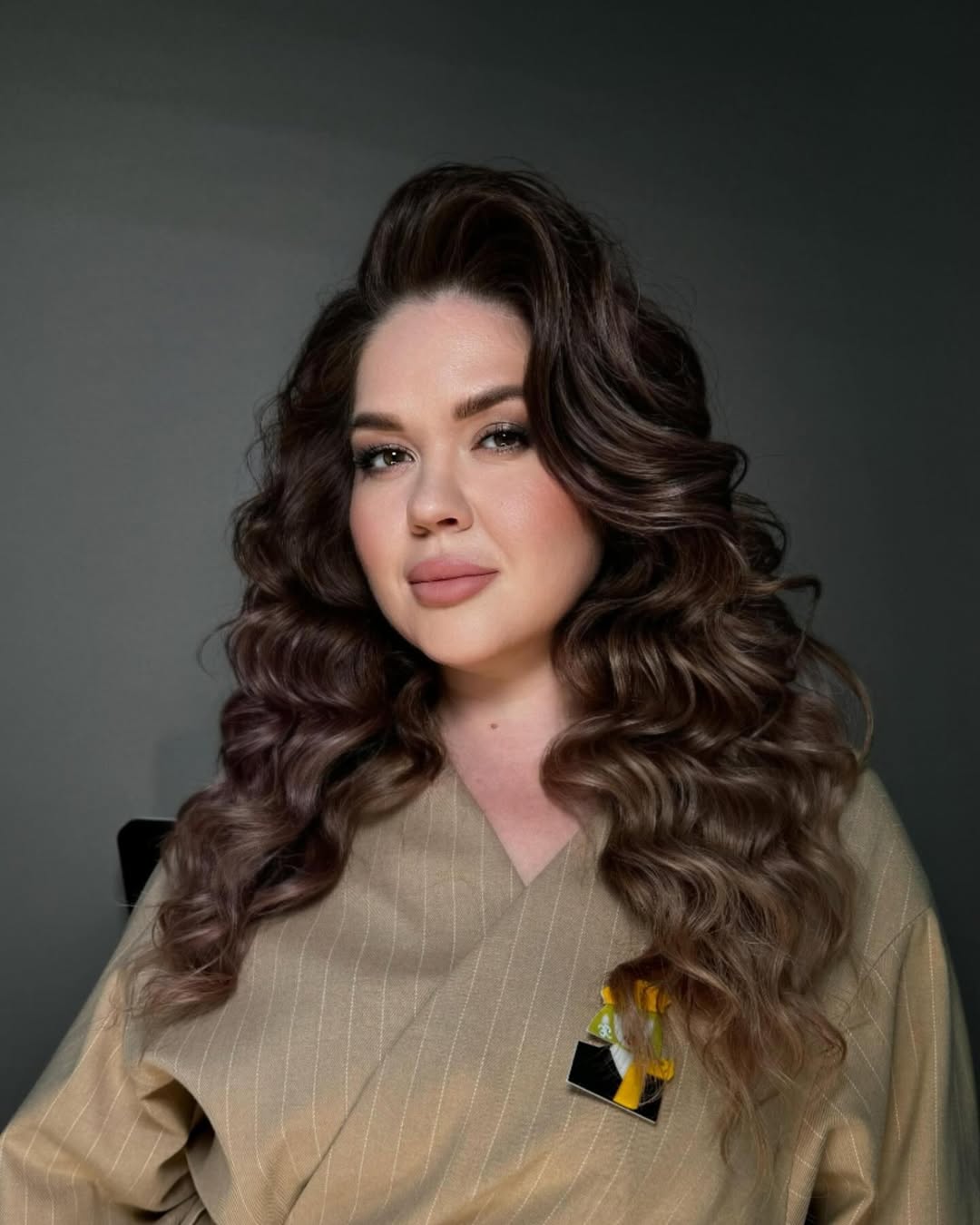 Blonde woman with chic braided summer hairstyle for long hair 2026, featuring a loose, messy plait perfect for a casual day or beach outing.