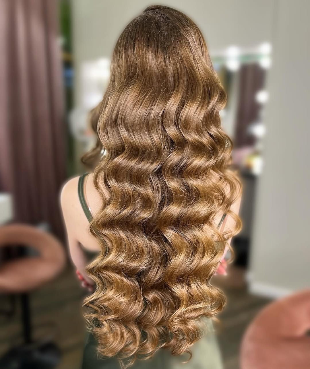 Beautiful woman with long, shiny blonde hair styled in a chic half-up braid, perfect for summer hairstyles for long hair 2026. Her elegant updo with soft waves frames her face, ideal for sunny days or special events.