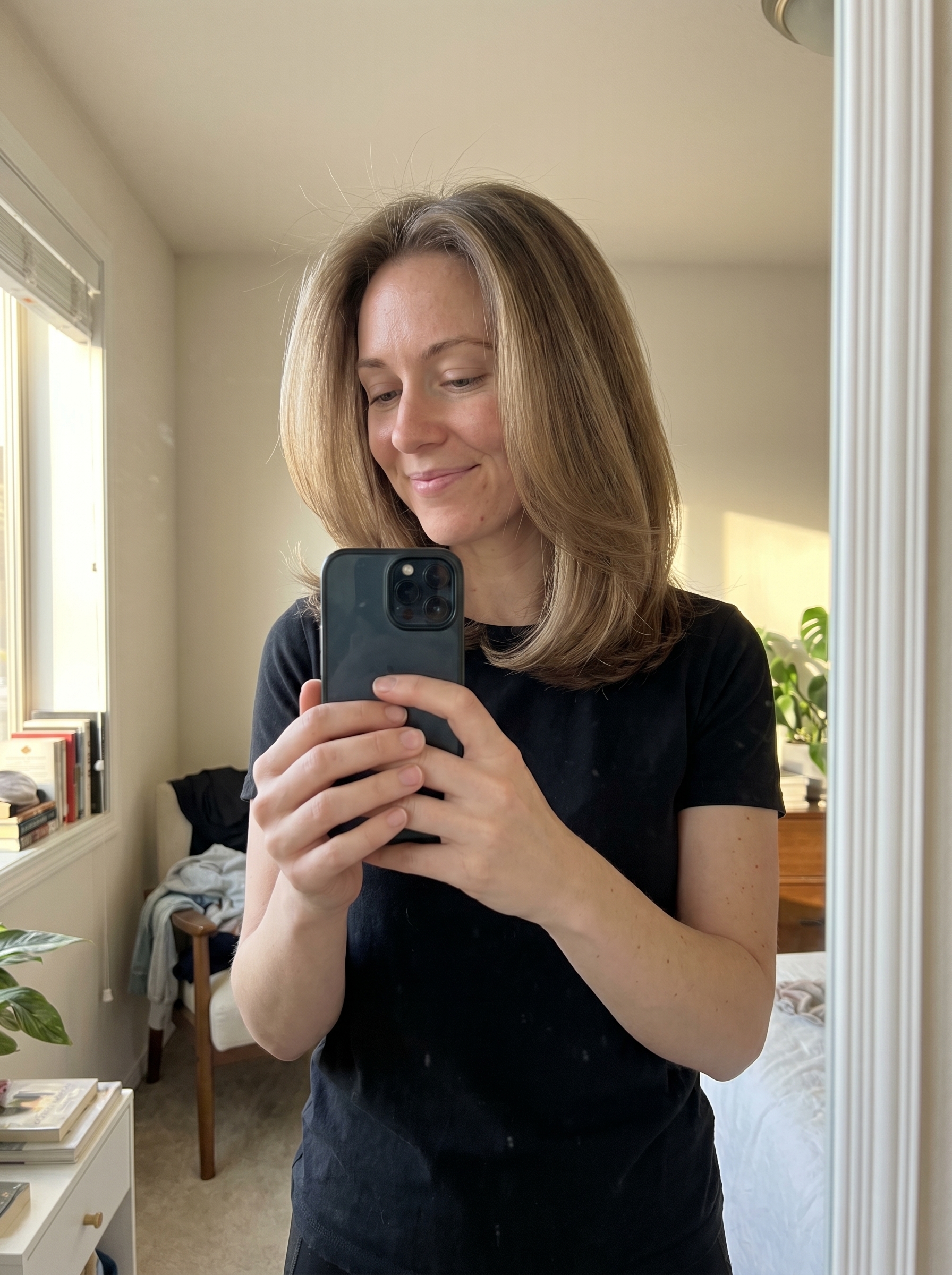 A polished Hydro-Silk Blowout featuring internal ghost layering, a sophisticated choice among summer hairstyles for long hair 2026. This luxe style, with its glass-like finish, is perfect for work, date night, or special events, exuding elegance.