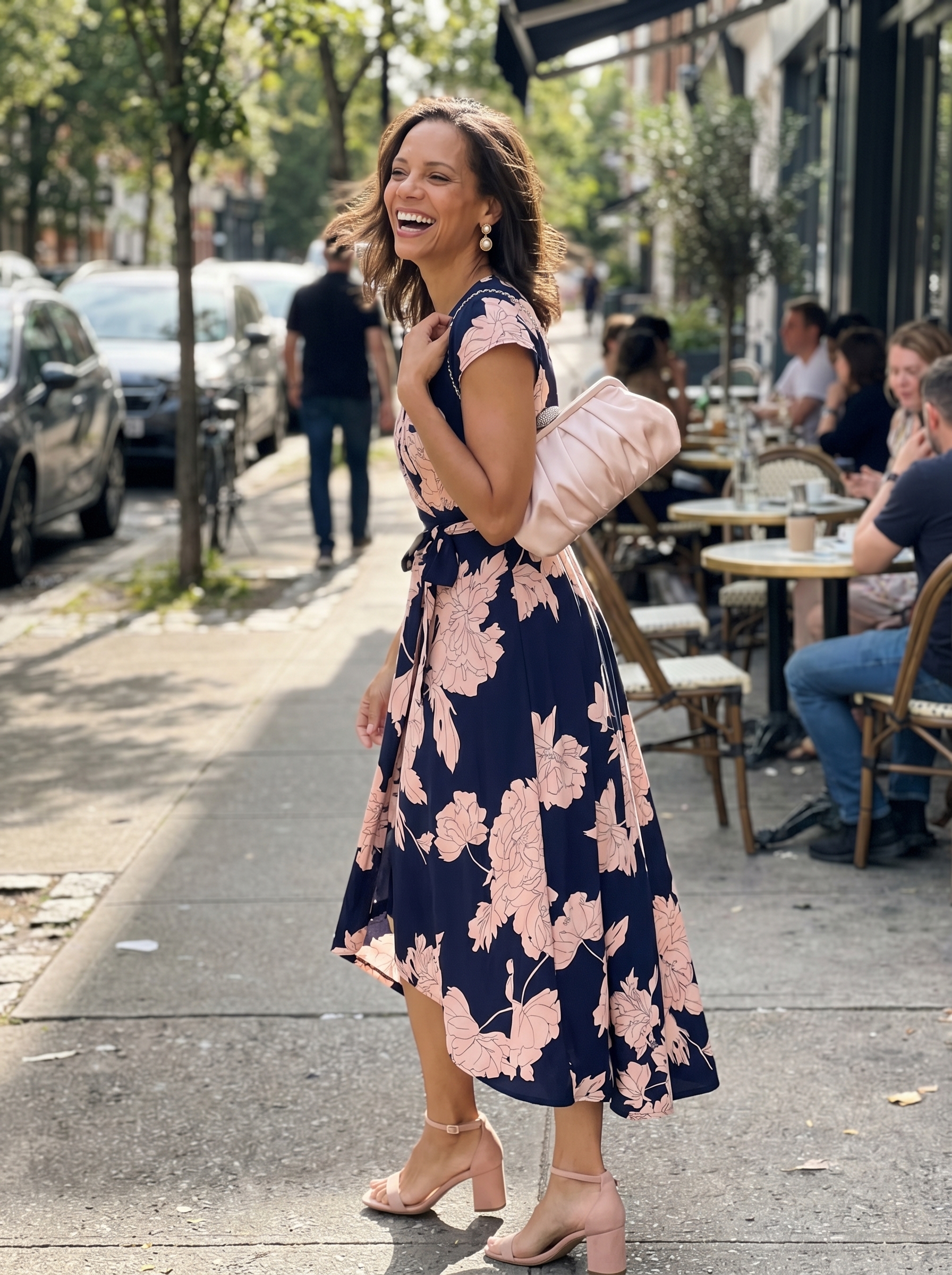 Elegant garden party summer mom outfit featuring a navy and pink floral midi dress, nude block heel sandals, and a blush pink clutch. Perfect for a chic 2026 summer wedding guest look.