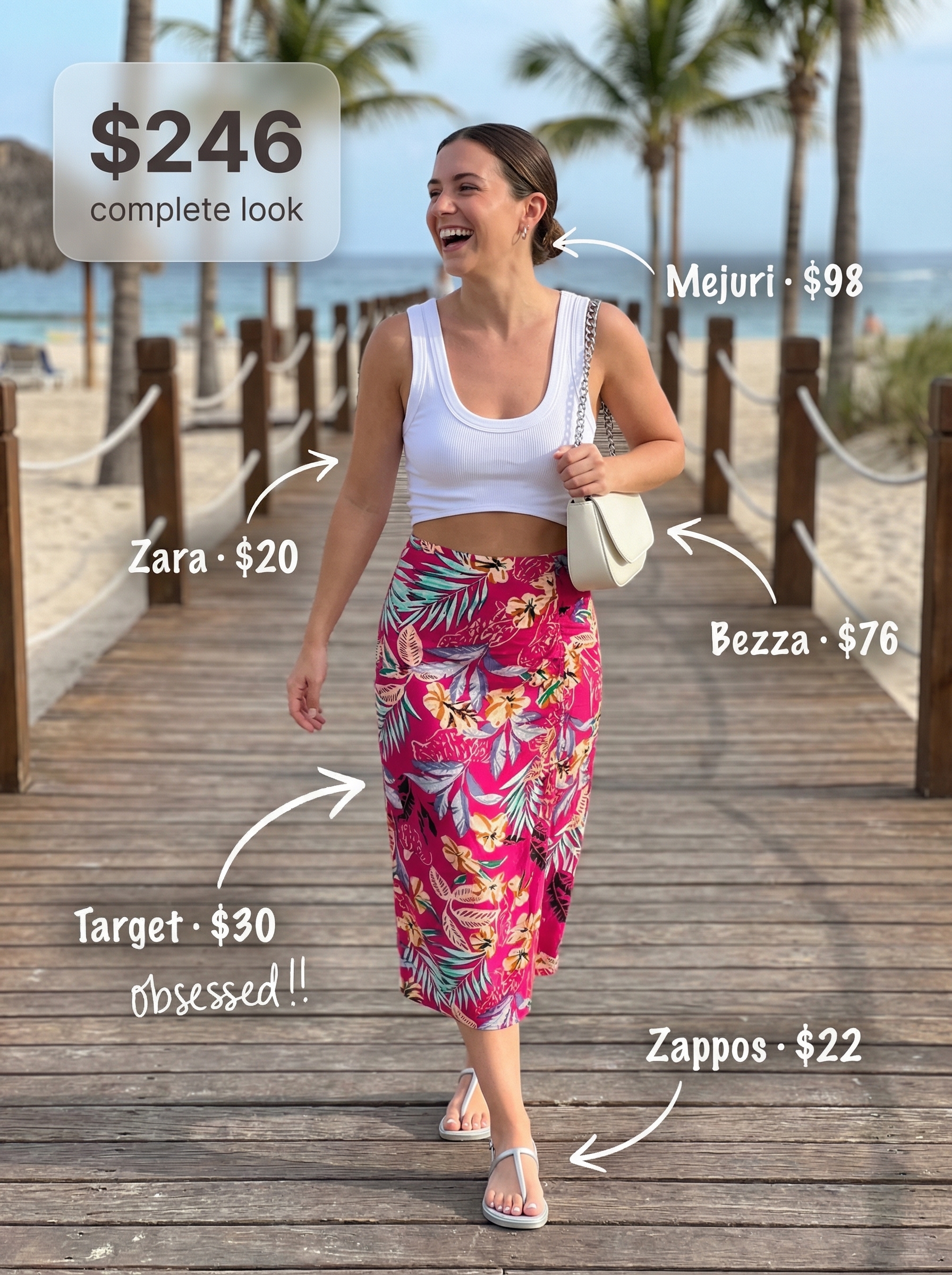 Glamorous summer vacation outfit showcasing a hot pink floral midi skirt, white crop top, silver thong sandals, and mini shoulder bag.