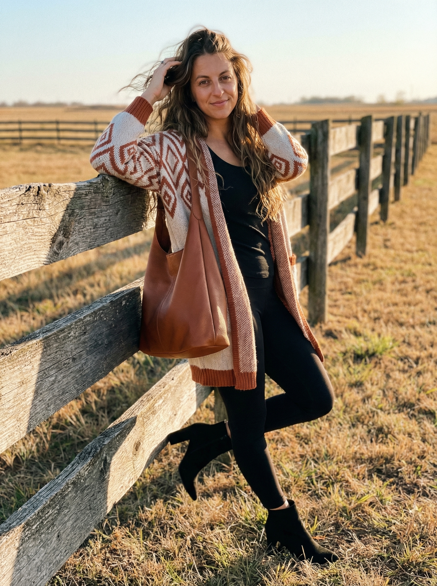 A cozy western chic look featuring a cream and rust Southwestern patterned cardigan over black leggings and ankle boots, perfect for travel.