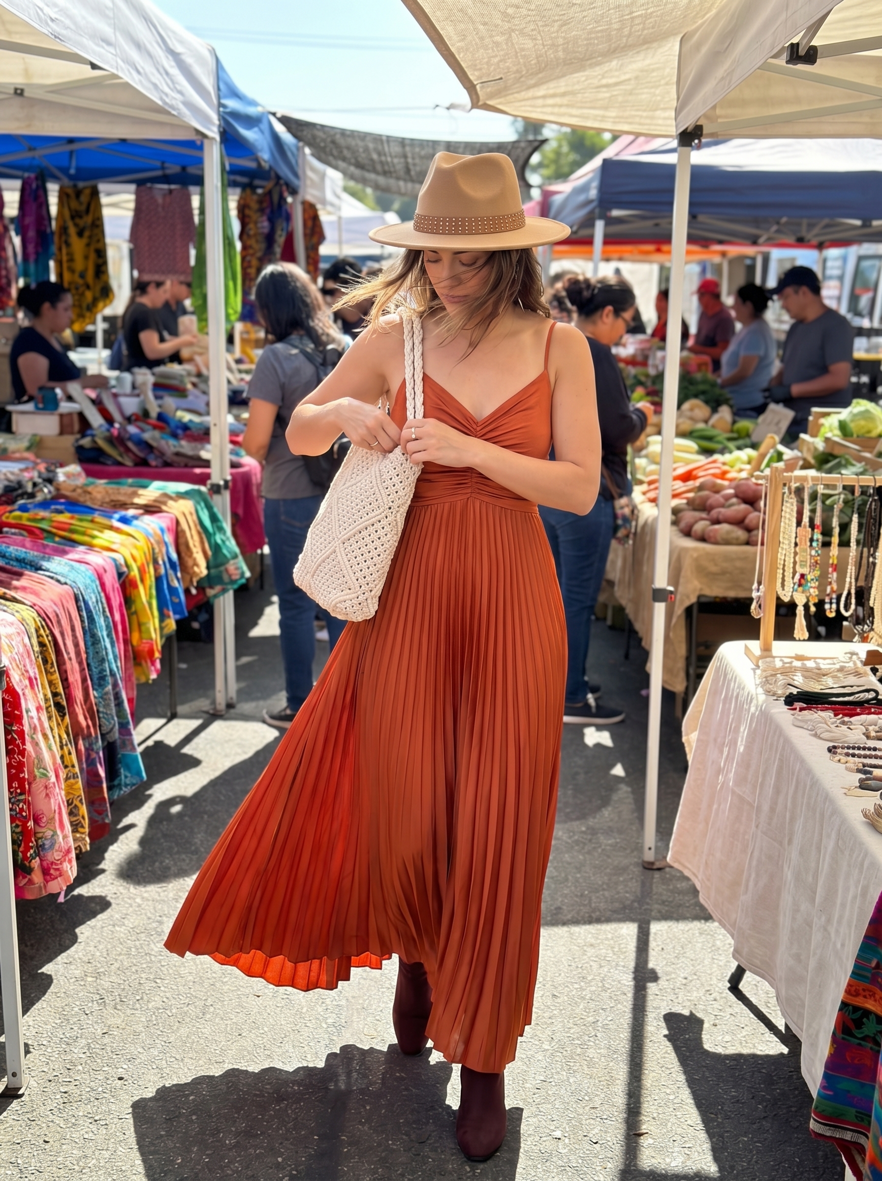 Effortless western summer outfit 2026: a terracotta flowy maxi dress, distressed brown ankle boots, a cream macrame shoulder bag, and a wide-brim felt hat for a festival.