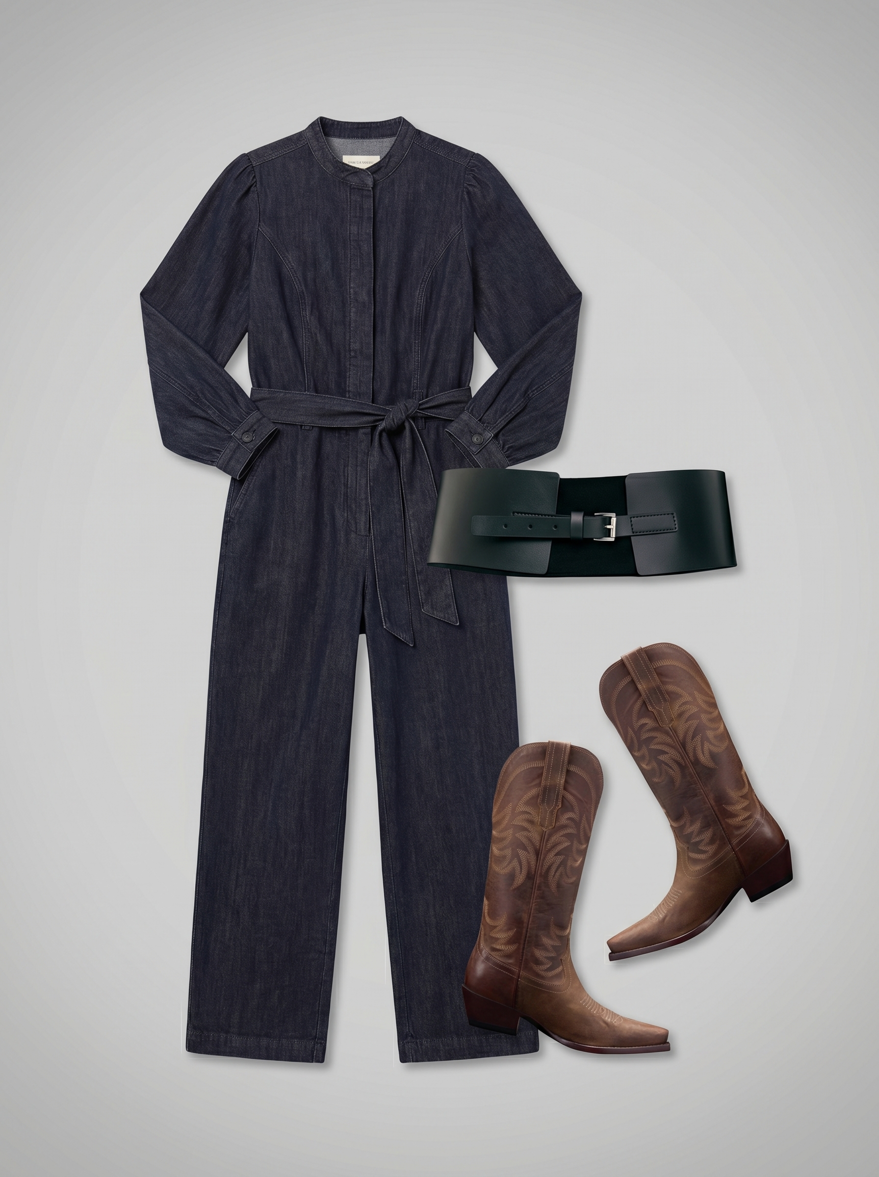 Cool western summer outfit 2026: a dark wash denim jumpsuit, classic cowboy boots, a small crossbody bag with tooling, and a wide belt for a road trip.