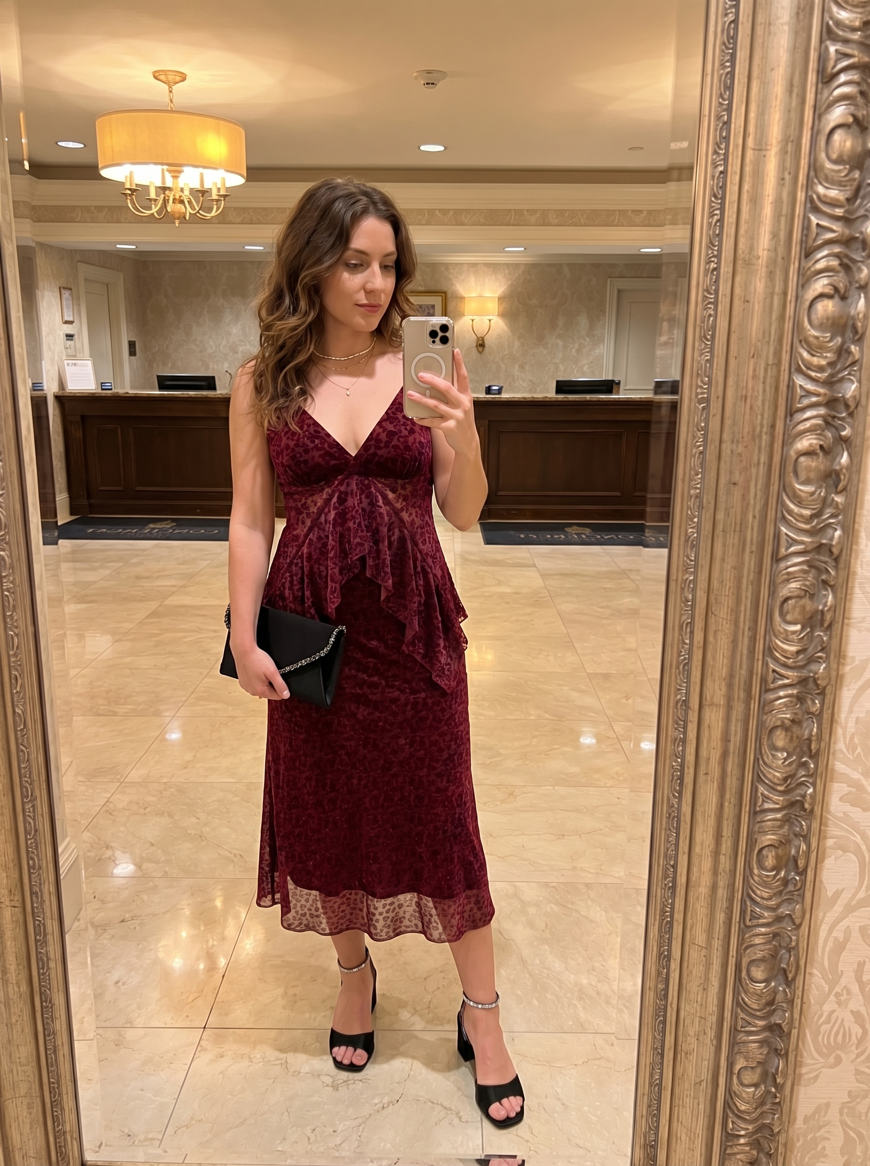 Luxurious Y2K summer outfit 2026 featuring a burgundy velvet crop top and matching midi skirt set, black strappy heels, a rhinestone clutch, and delicate gold necklaces for date night.