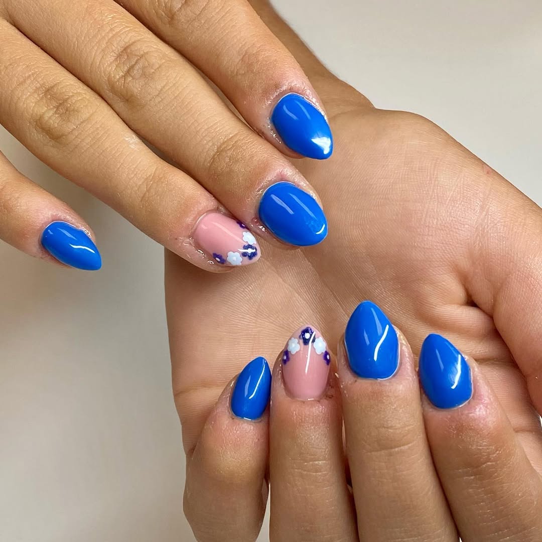 Bright Blue Almond Nails with Delicate Floral Accents