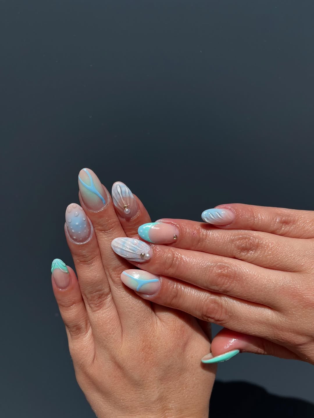 Coastal Blue Swirls and Pearlescent Seashell Almond Nails