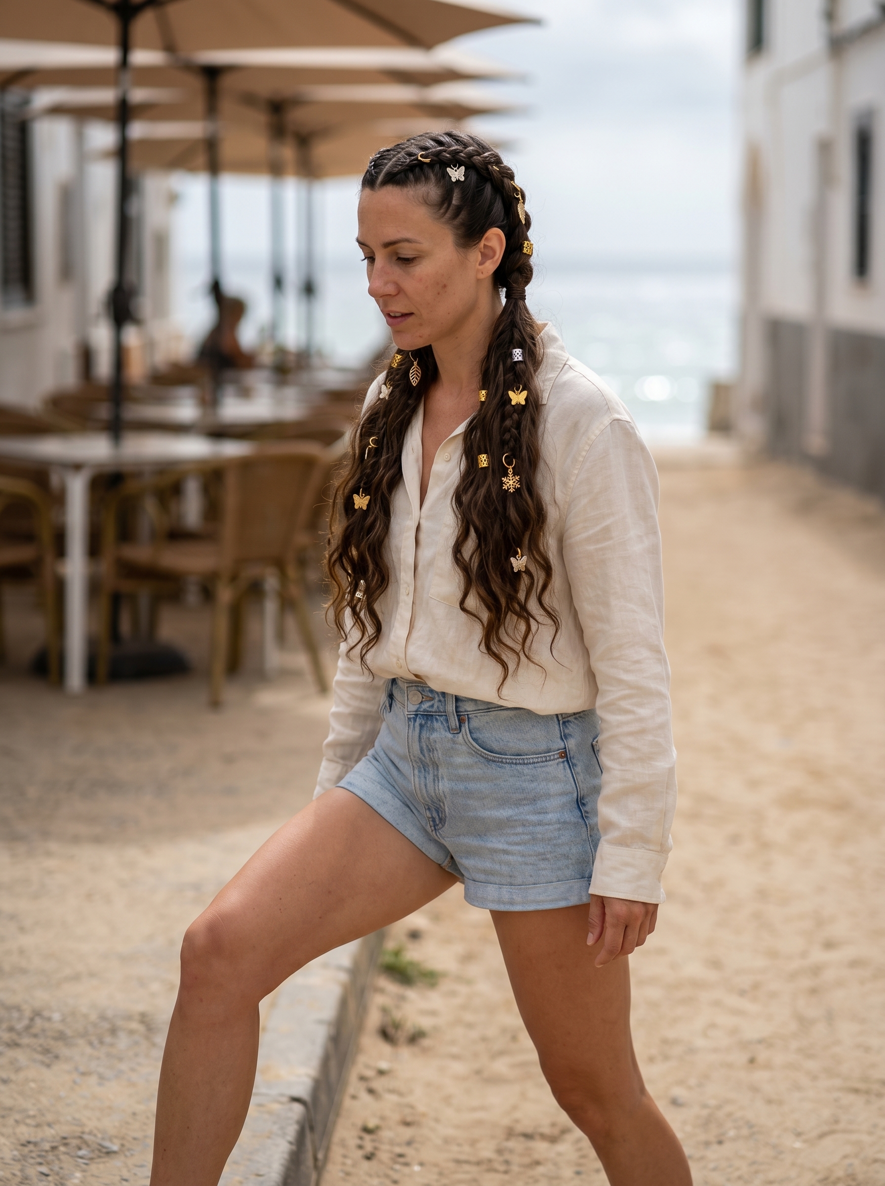 Playful butterfly braids adorned with metallic charms, an edgy and fun option for cute summer hair ideas 2026 suitable for everyday or beach/resort wear.