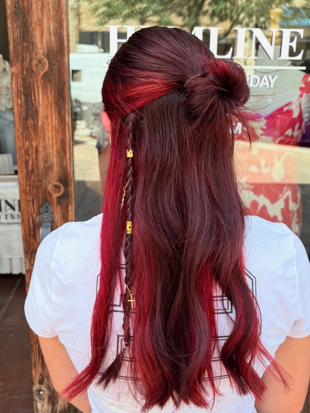 A young woman with a cute summer hairstyle, featuring long, wavy brown hair with subtle blonde highlights, styled in a half-up twist with a delicate pearl clip, perfect for a casual sunny day. This look is one of the best cute summer hair ideas for 2026.