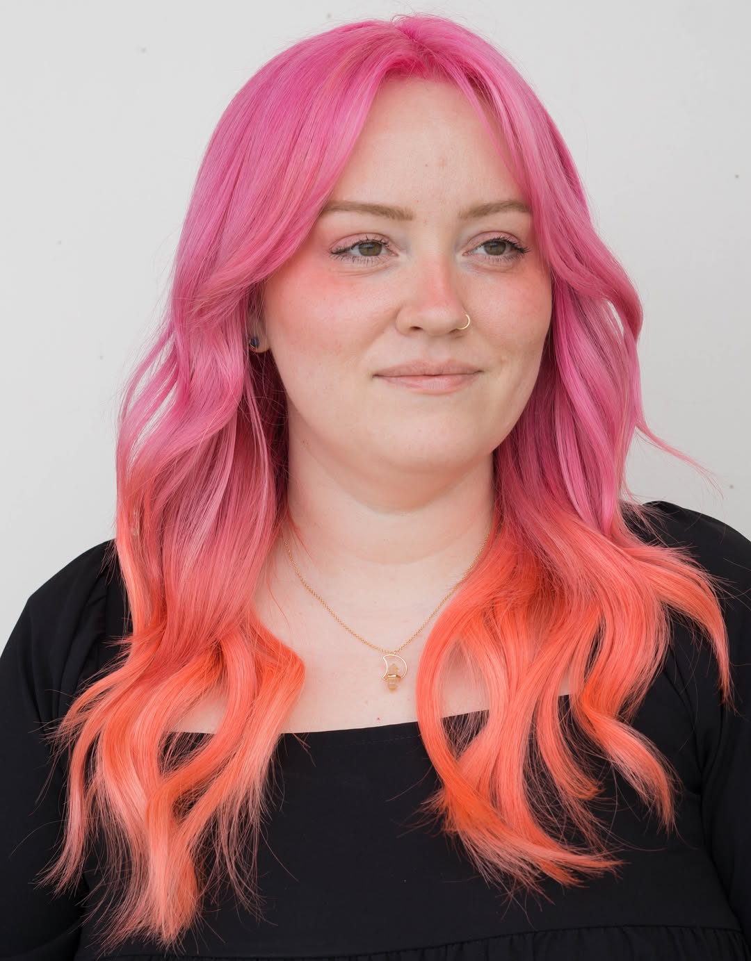 Close-up of a woman with long, sun-kissed blonde hair styled in soft, loose waves with a cute summer hair accessory. Perfect for beach days or casual outings.
