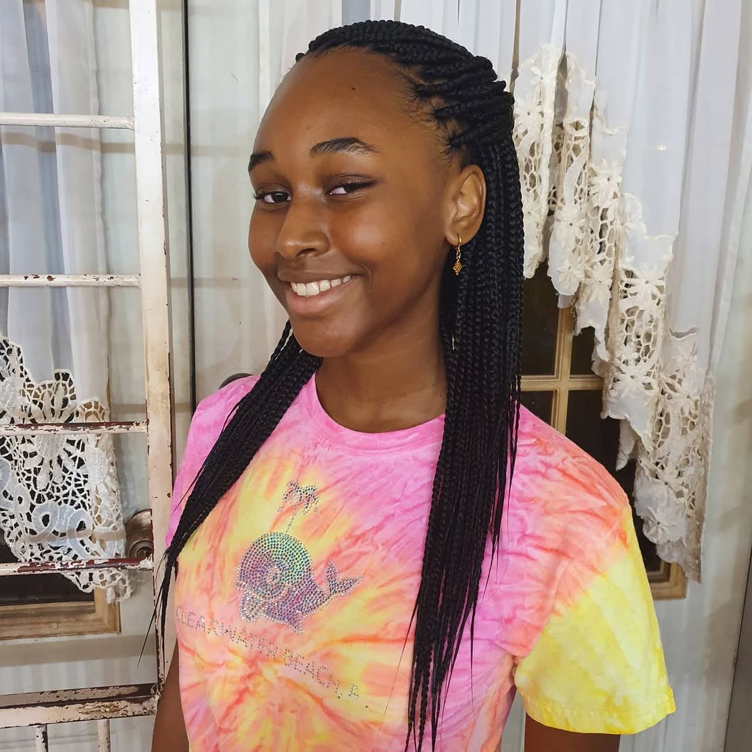 Close-up of a teen girl with long, wavy blonde hair in a half-up twist, perfect for cute summer hairstyles for teens. She wears a floral dress and delicate earrings, embodying a fresh, youthful summer look. Ideal for casual outings.