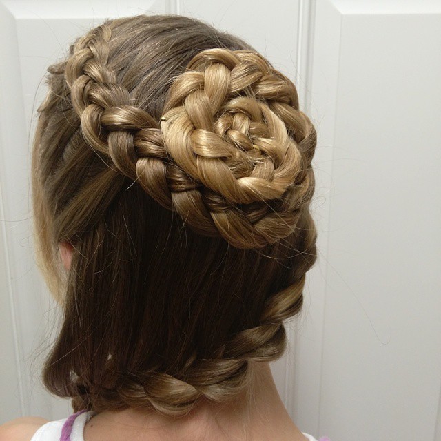 Girl with long blonde hair in a messy high bun, perfect cute summer hairstyle for teens, styled with a colorful scrunchie for a casual, warm weather look.