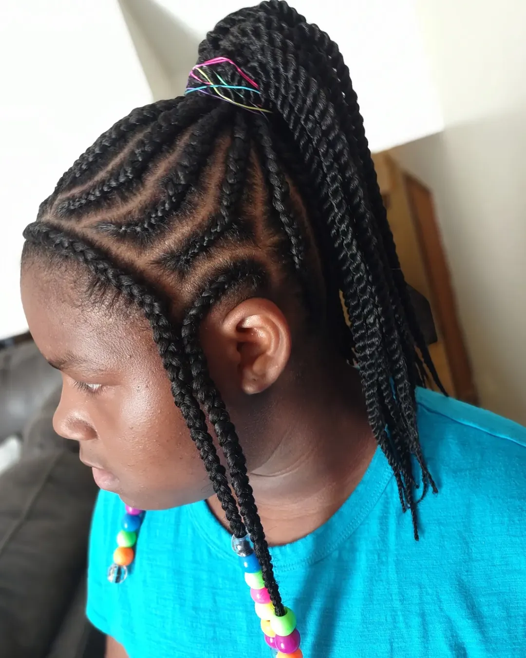 Close-up of a teen girl with long, wavy blonde hair styled in a half-up messy bun, paired with a colorful floral top, perfect for cute summer hairstyles for teens 2026.