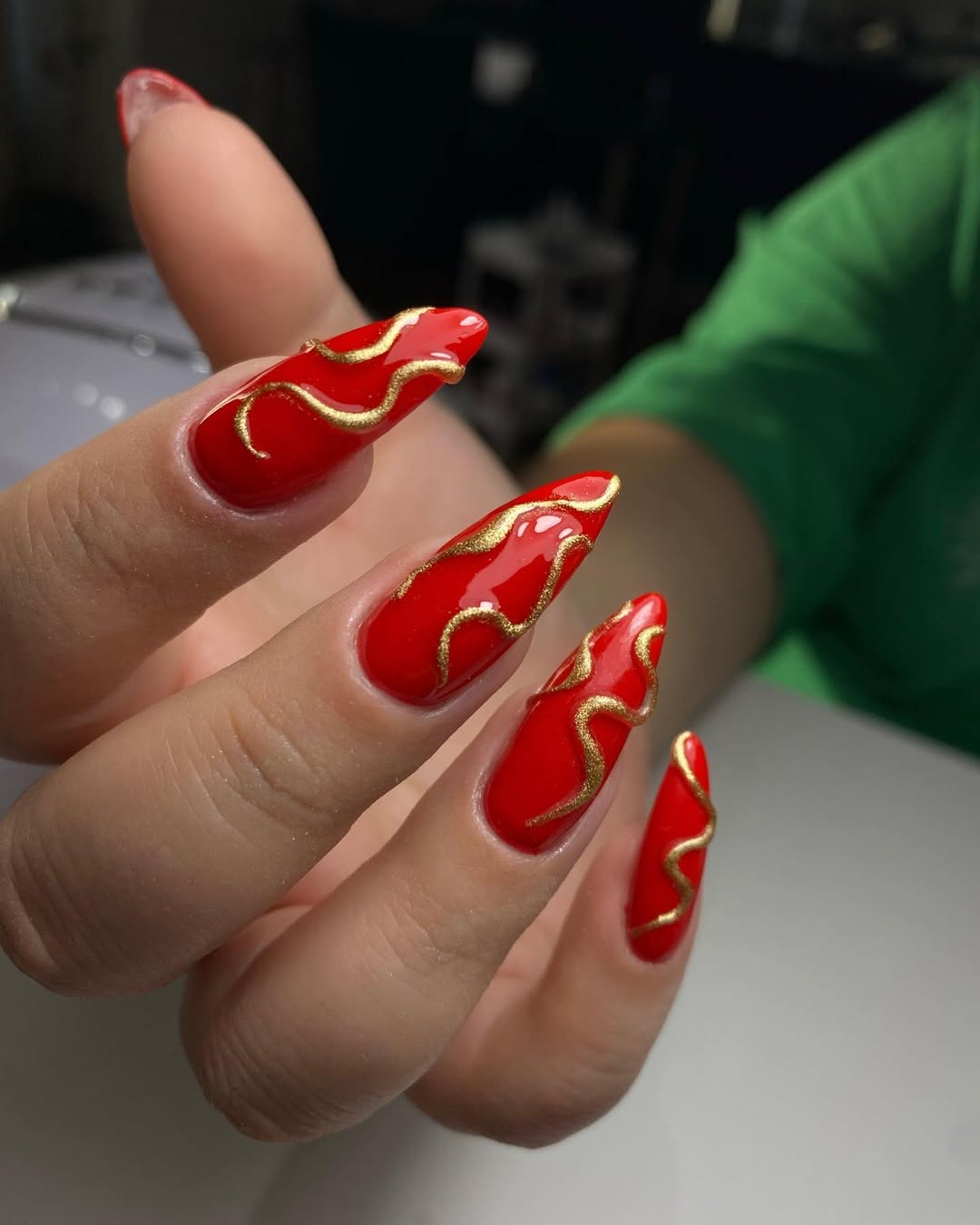 Fiery Red Stiletto Nails With Gold Wave Art