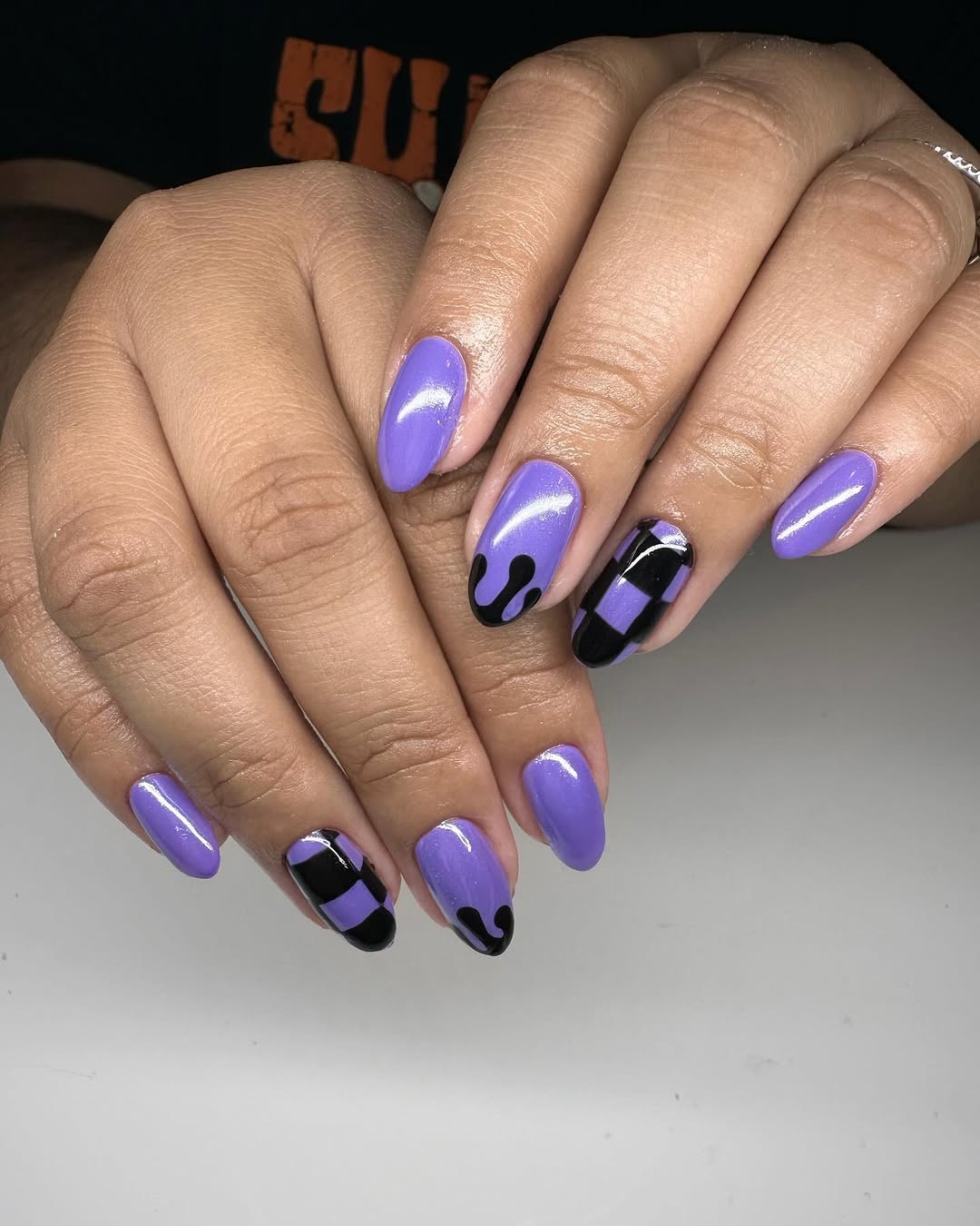 Fun Purple Drip and Checkerboard Oval Nails