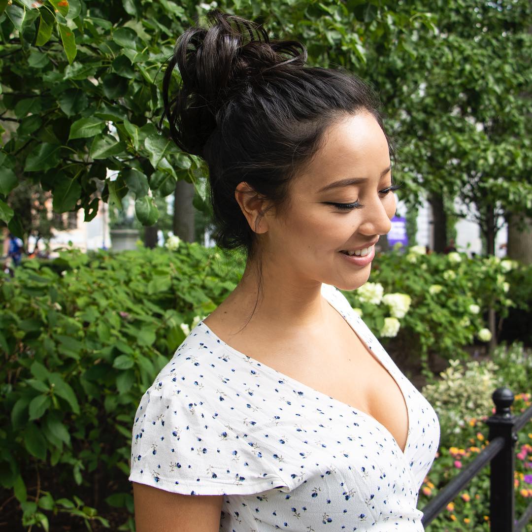 Woman with a chic low bun, perfect for hairstyles for hot weather 2026. The elegant updo keeps hair off the neck, ideal for warm climates and sophisticated occasions.