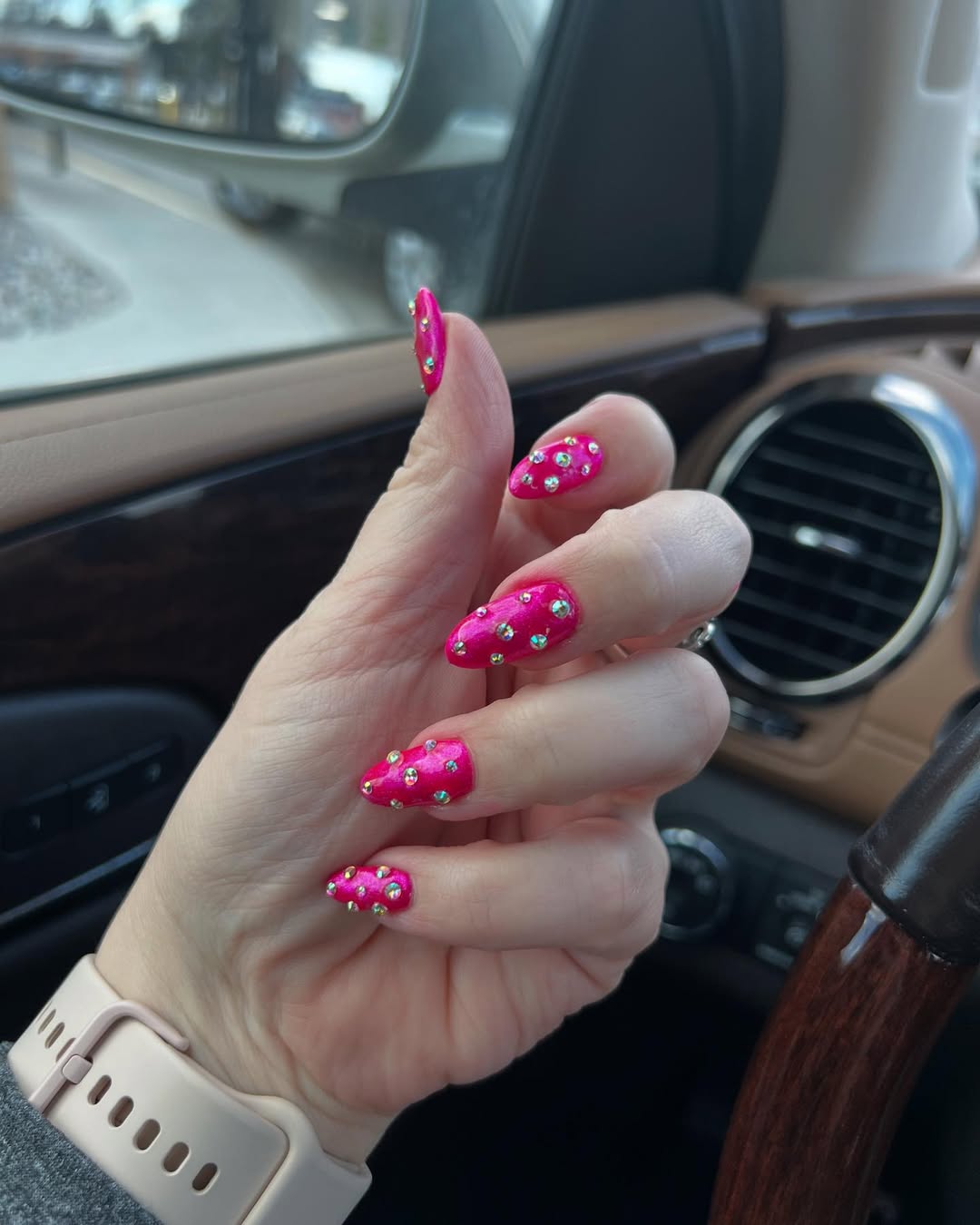 Hot Pink Almond Nails With Rhinestone Embellishments