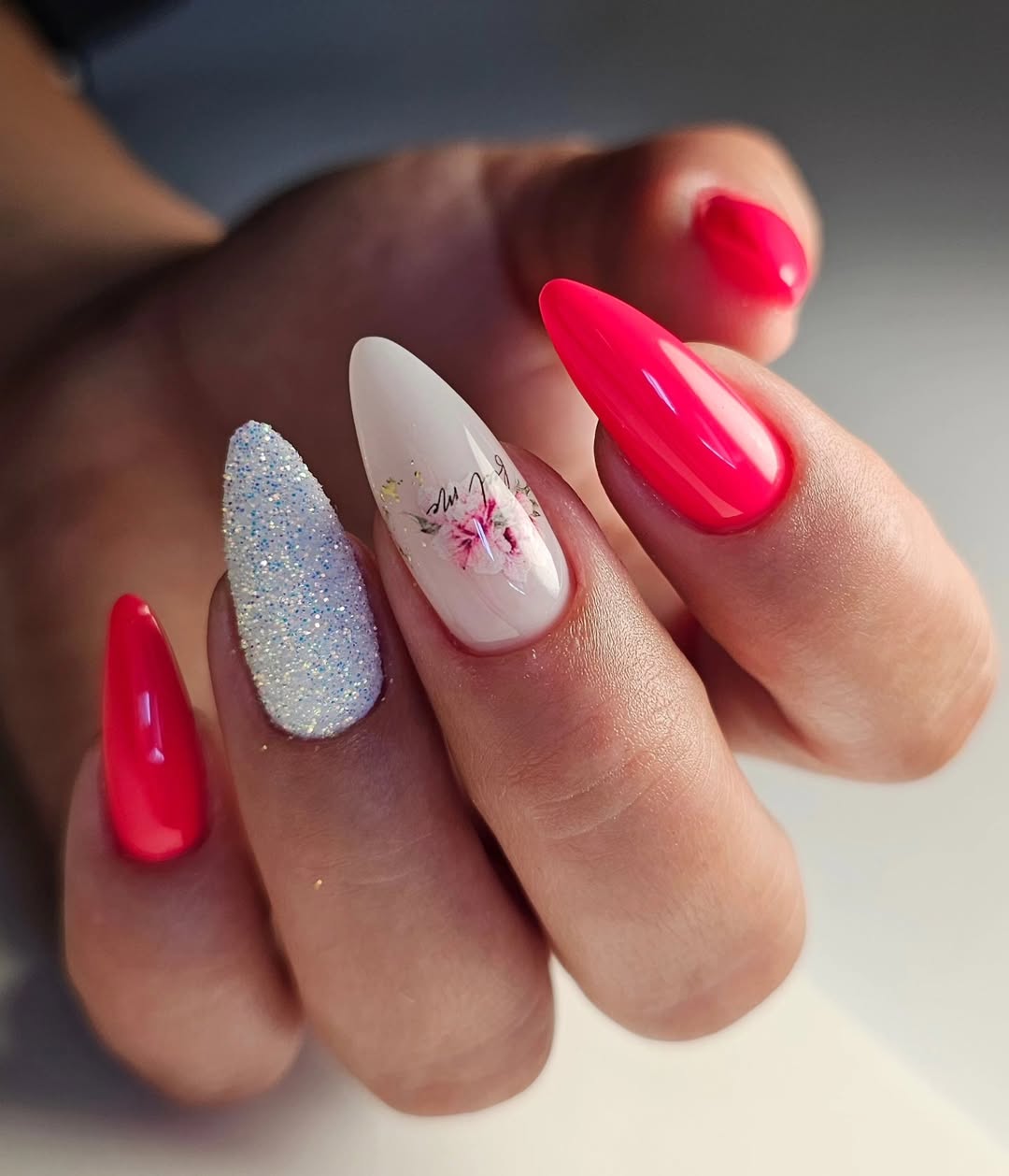 Hot Pink Gel Stiletto Nails with Glitter and Floral Accents
