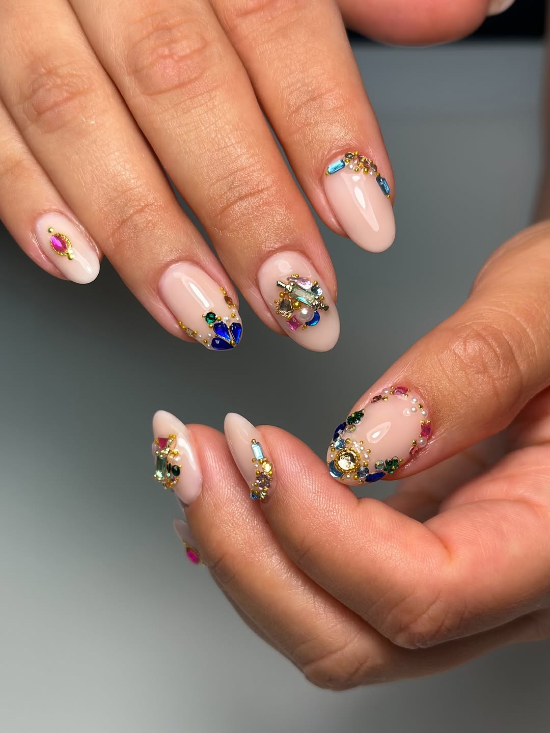 Luxurious Nude Almond Nails With Colorful Rhinestone Clusters