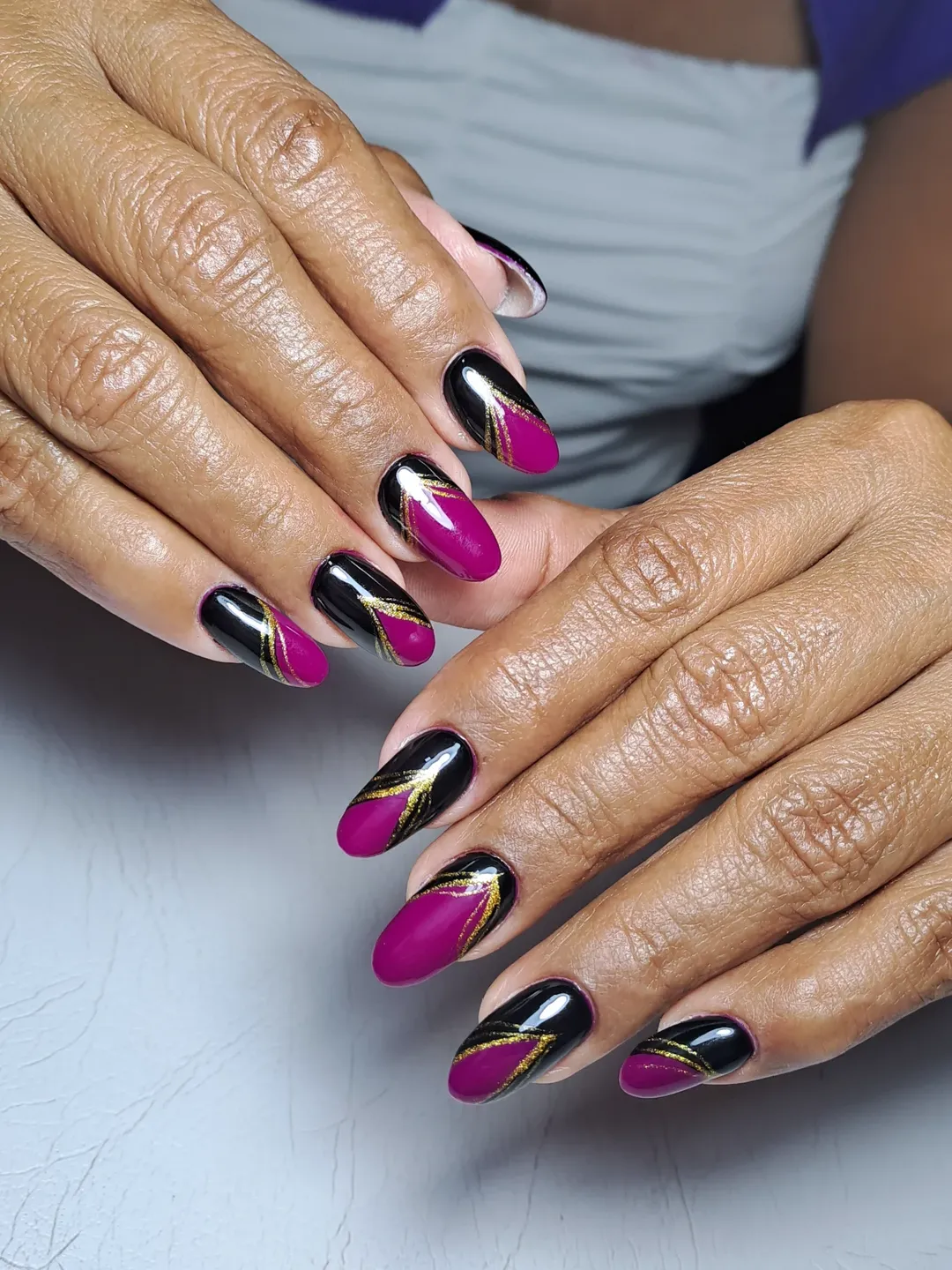 Magenta And Black Geometric Almond Nails With Gold Accents