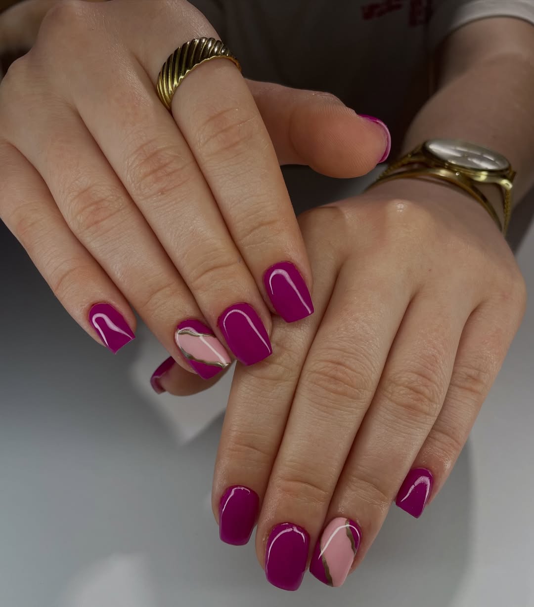 Magenta Glossy Nails with Pink and Gold Swirl Accents