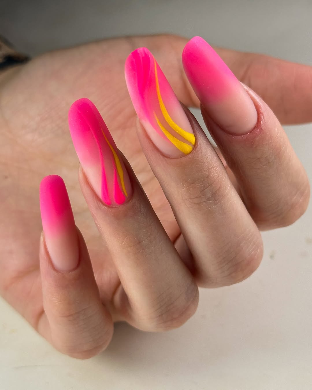 Matte Neon Hot Pink Ombre Coffin Nails with Yellow Swirls