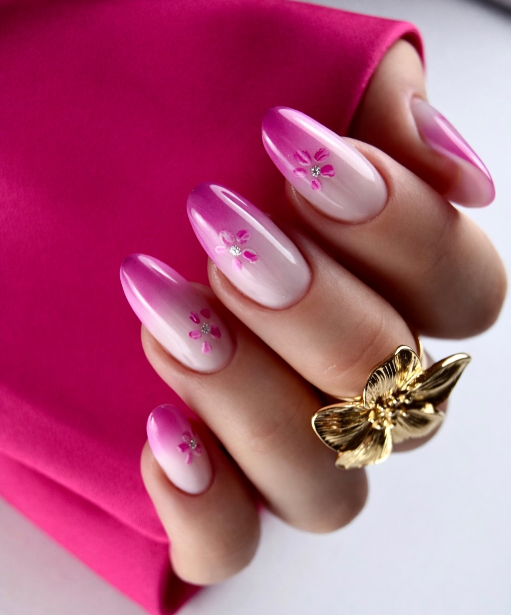 Ombré Hot Pink Almond Nails With Rhinestone Flowers
