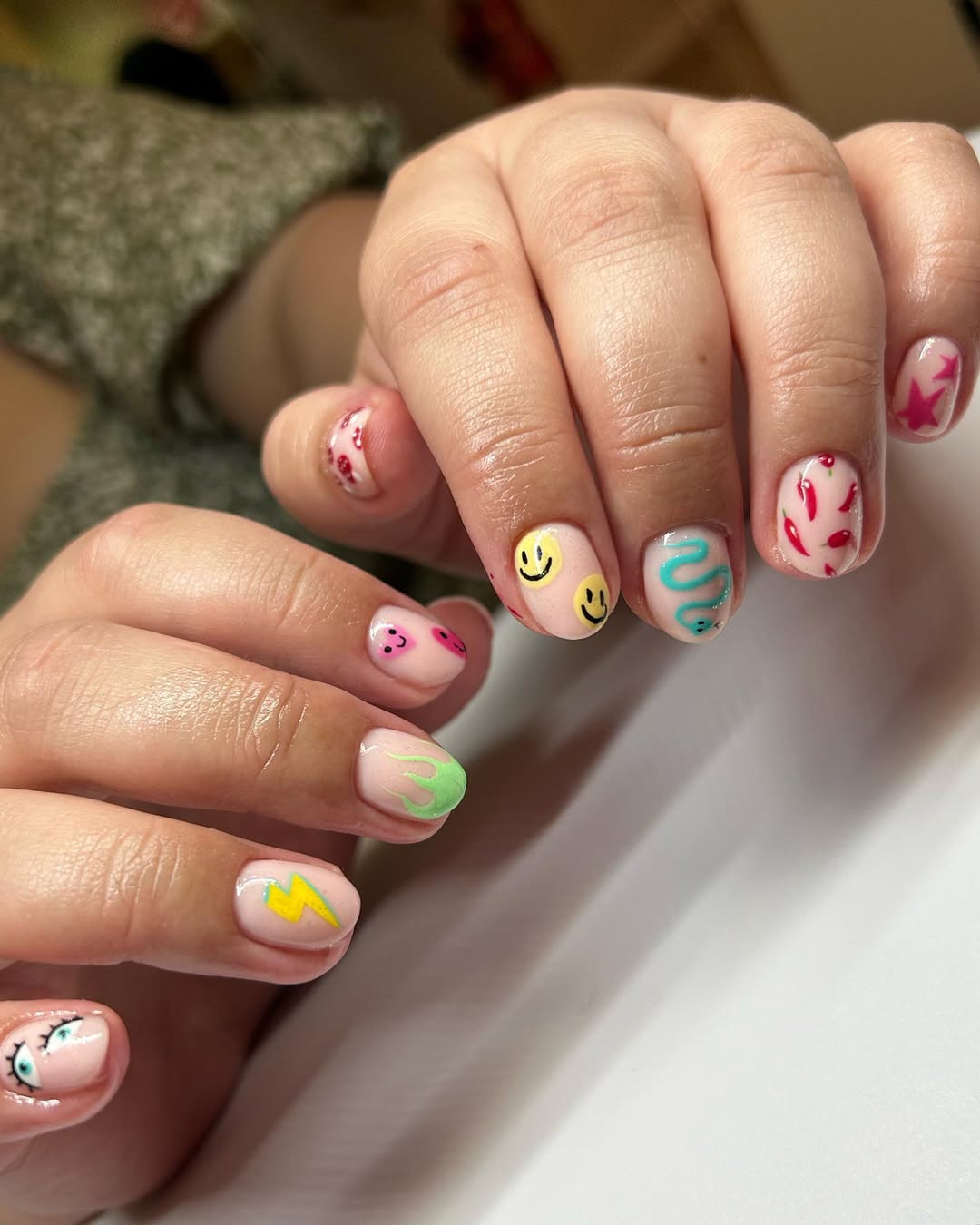 Playful Mismatched Smiley Face and Hot Pepper Nails