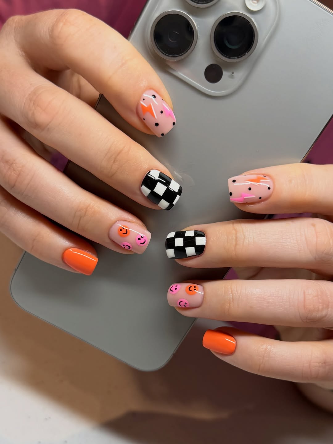 Playful Orange Checkered Smiley Face Nails