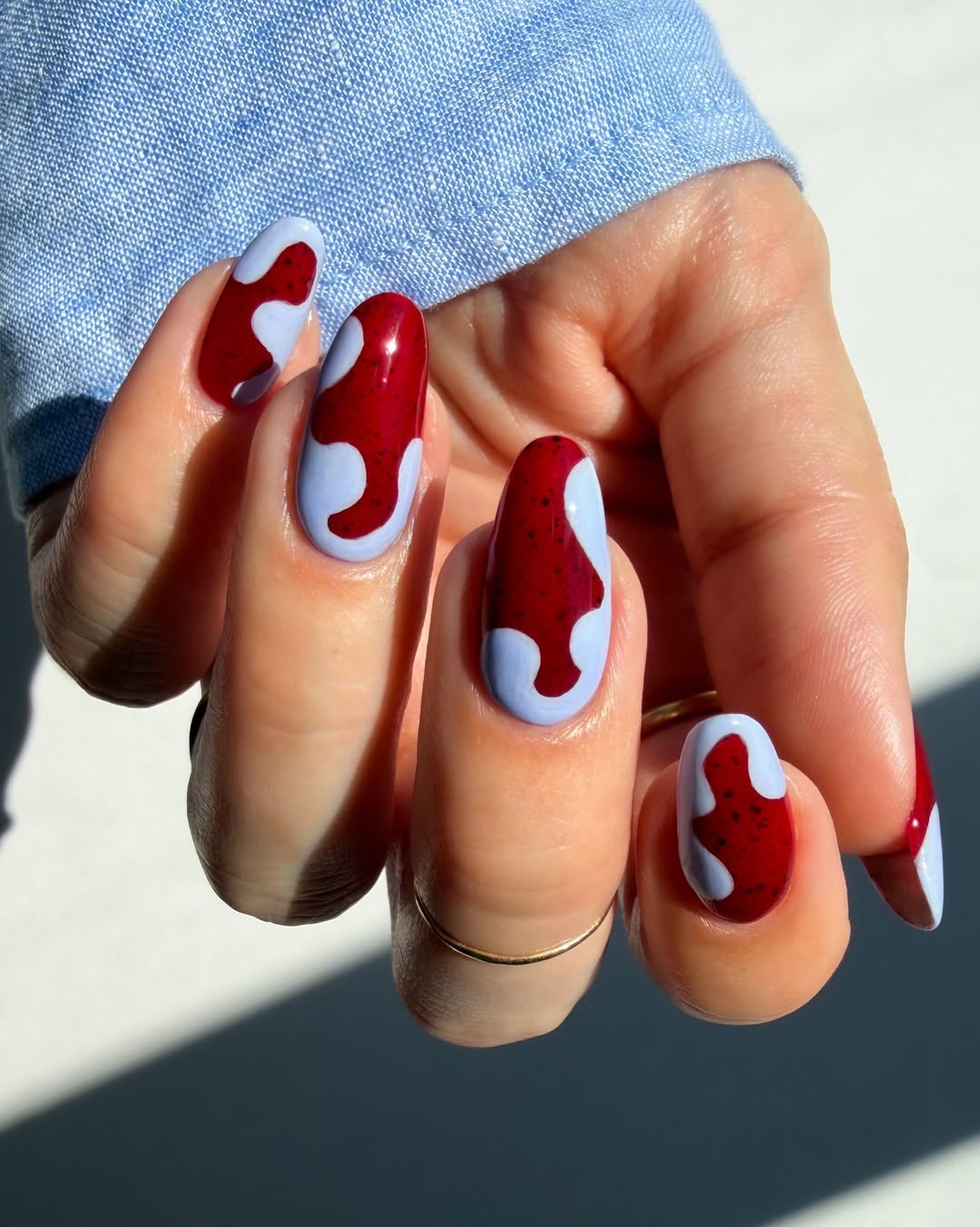Red Lava Lamp Swirls on Periwinkle Glossy Oval Nails