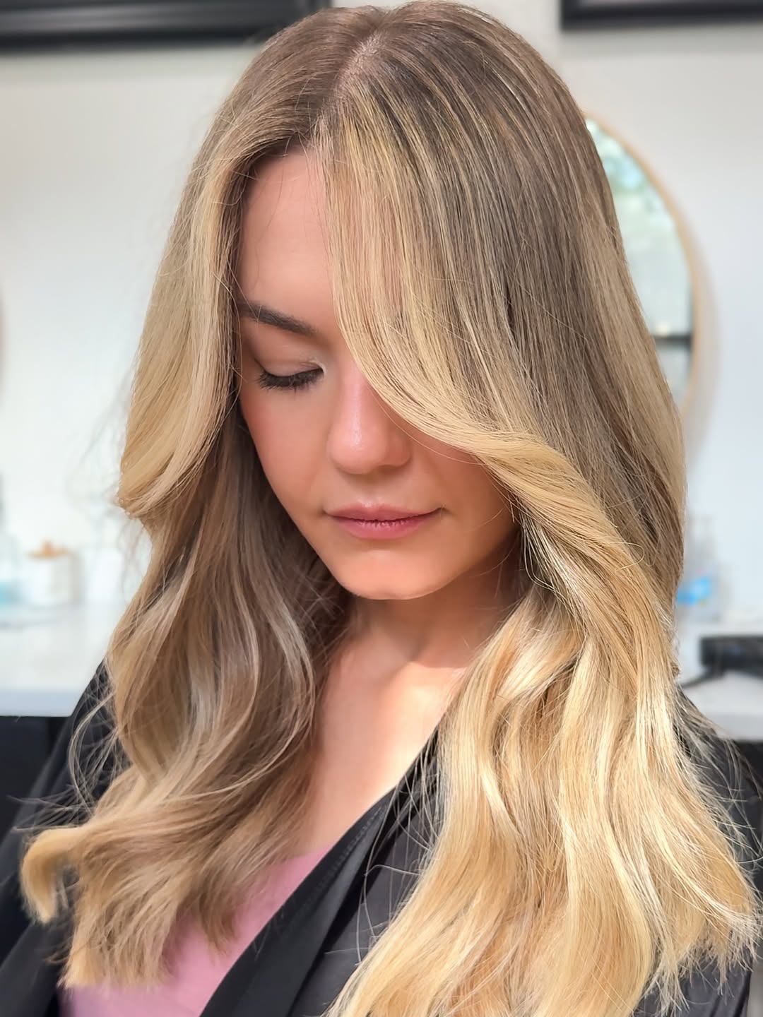 Close-up of a woman with natural, sun-kissed soft summer hair ideas 2026, styled in loose, beachy waves.